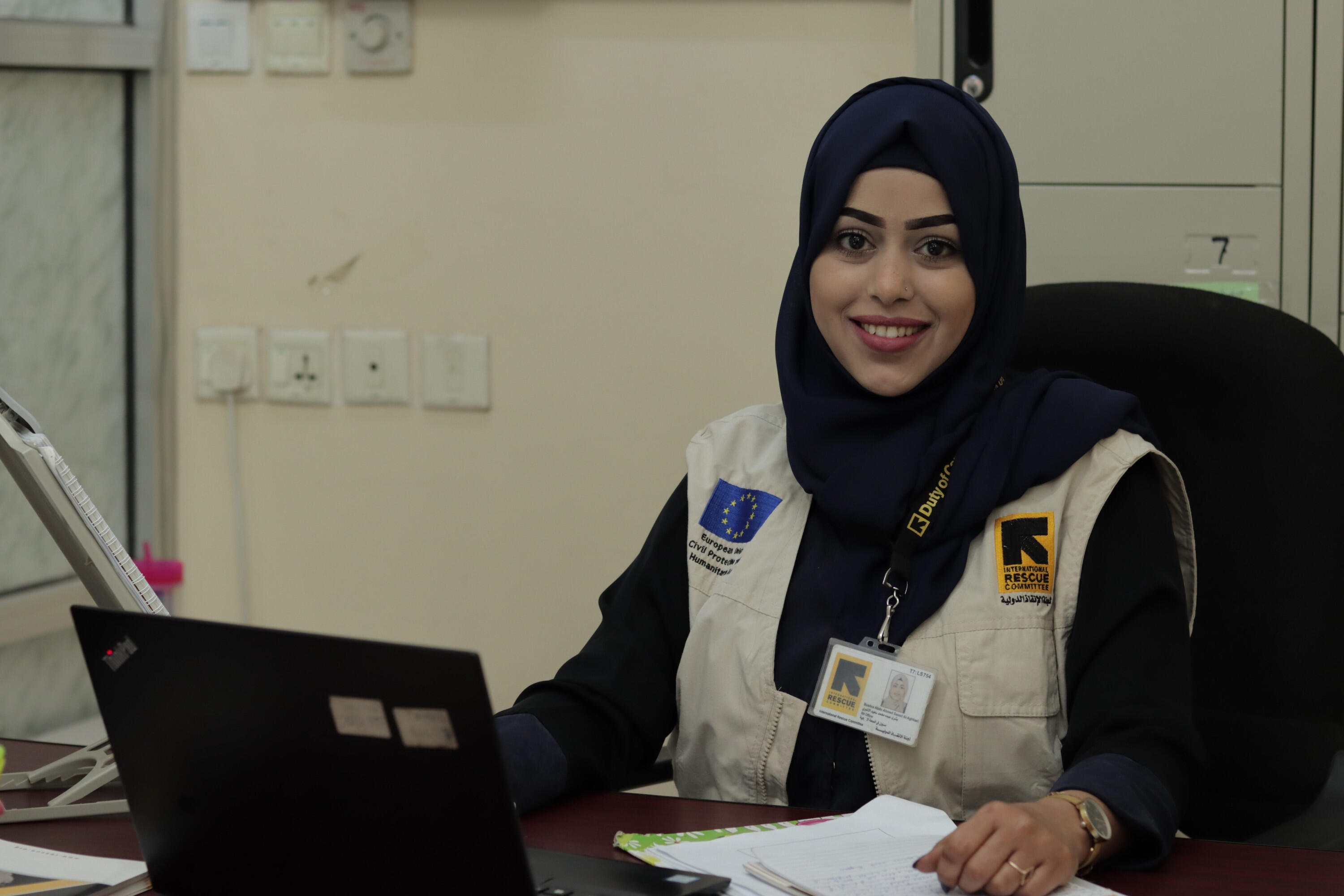 Bushra sitting at her work desk