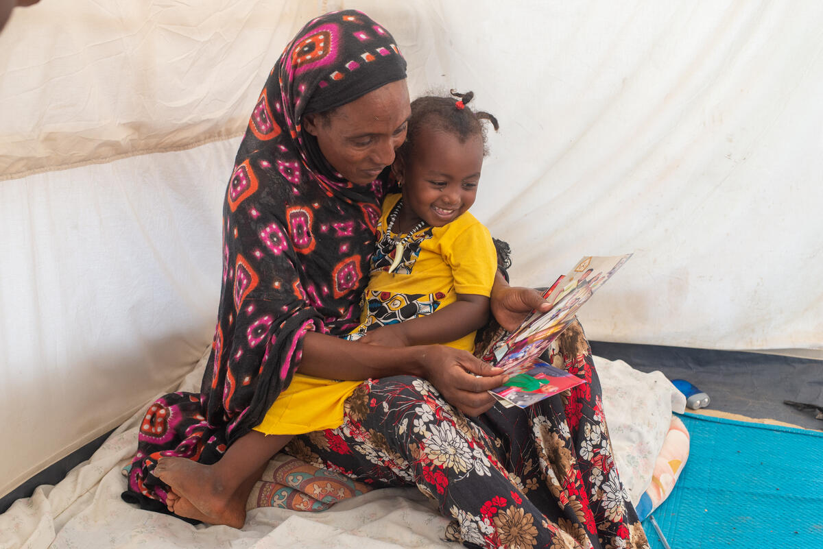 Mulu and her daughter looking at photos Mulu brought from Ethiopia