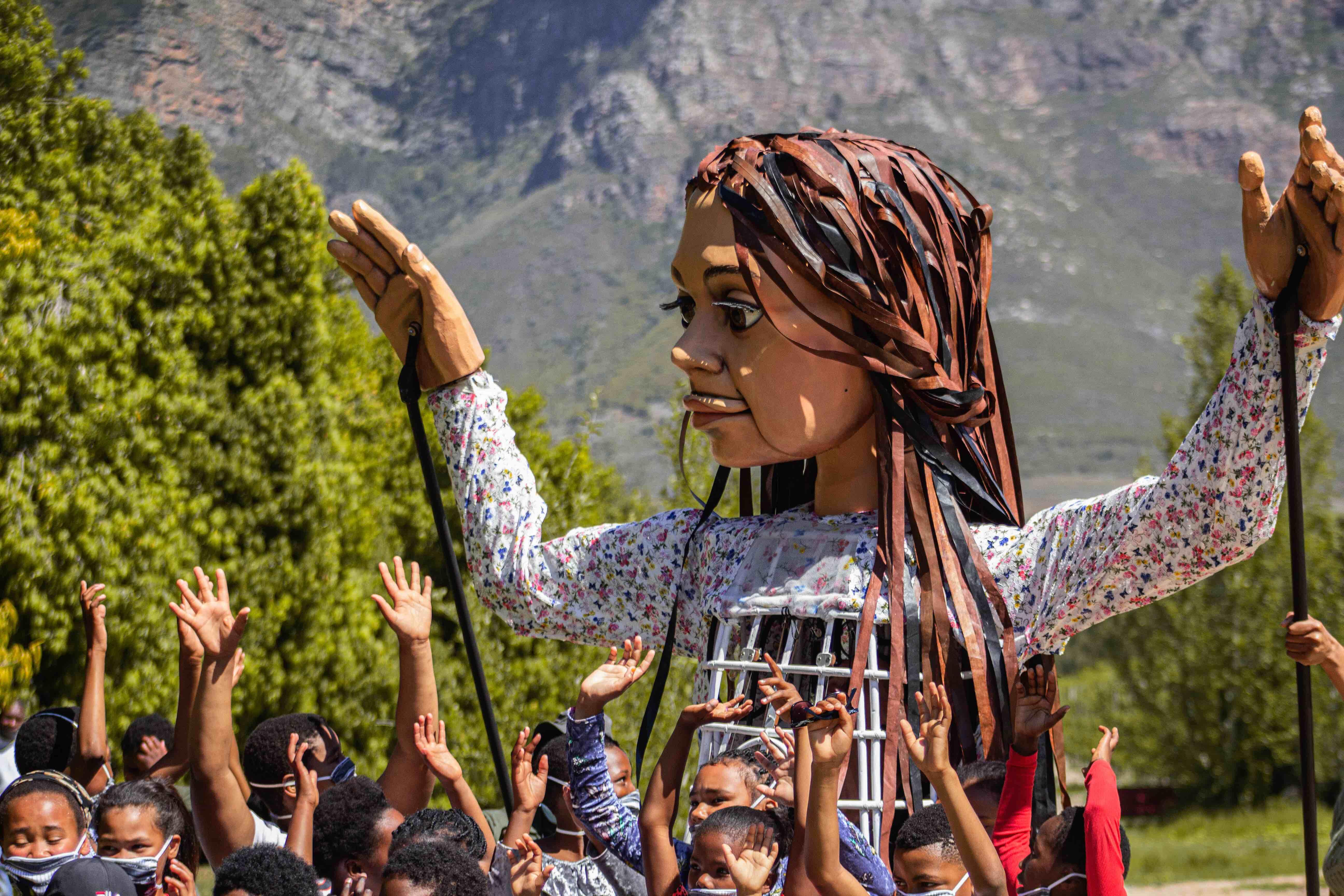Little Amal with children in Cape Town