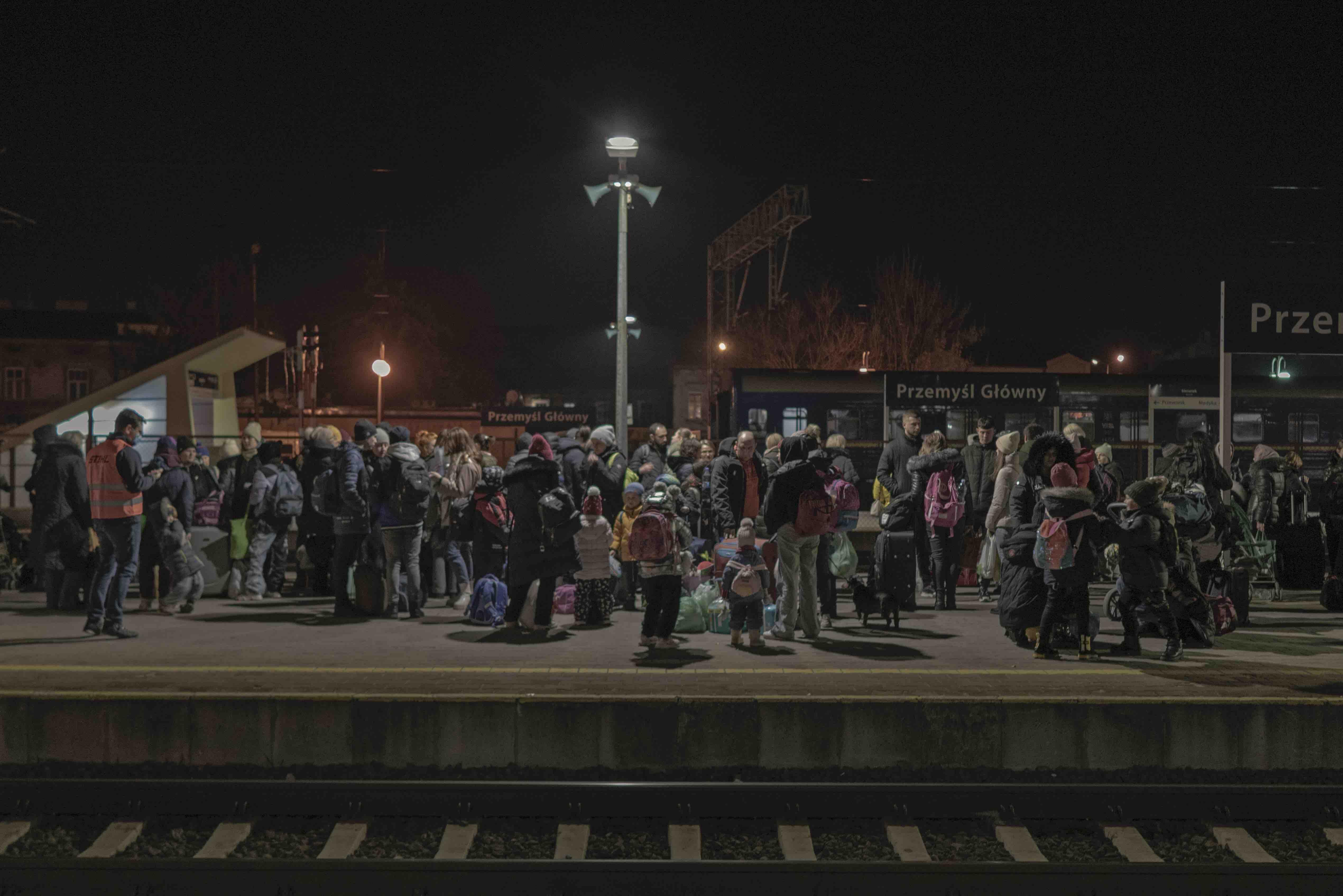 Ukrainian refugees wait at Polish railway station
