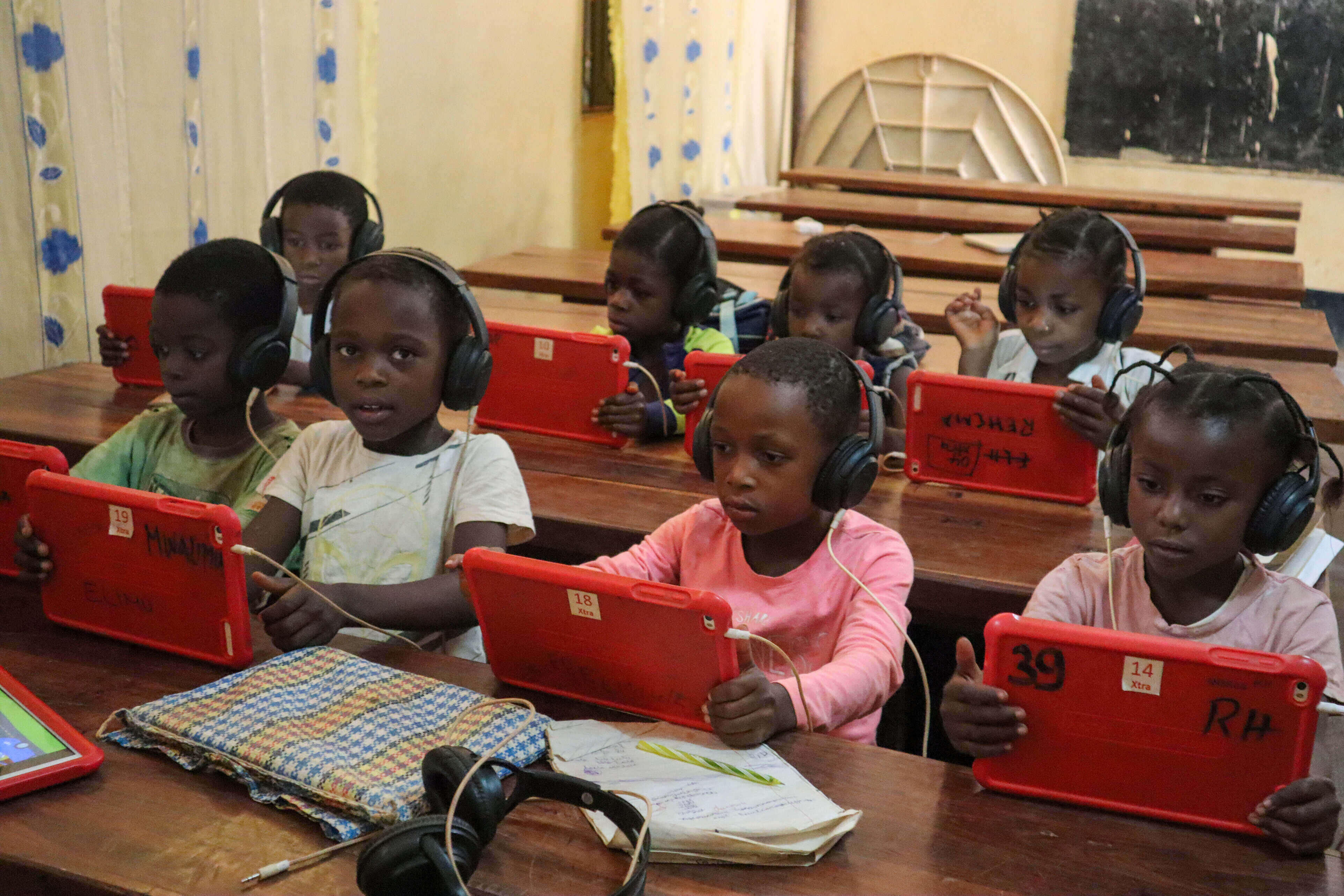 Schoolchildren in the Democratic Republic of Congo who receive support from the IRC use tablets that came as part of a classroom-in-a-box program funded by Vodaphone in collaboration with the UN Refugee Agency (UNHCR). Photo: Abbas Placide