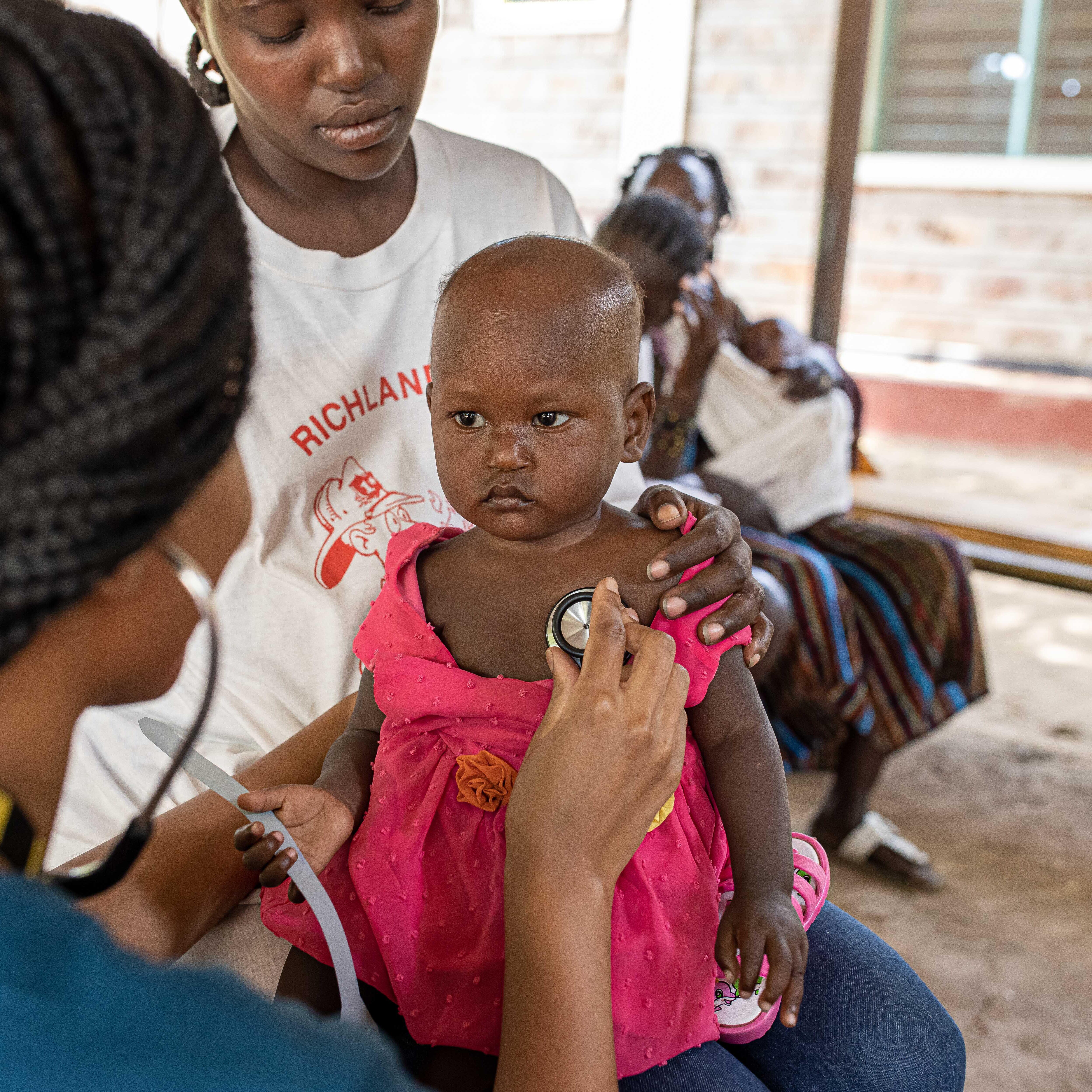 Dr. Monthe, a health manager for the IRC, checks baby Vanessa for malnutrition in Kakuma Refugee Camp.