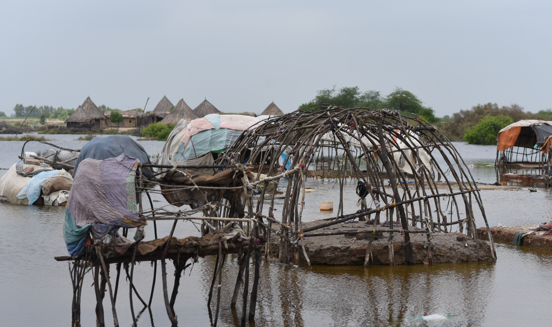 Destroyed homes were left with only wooden support beams standing. The rest of the homes were washed away by floods.