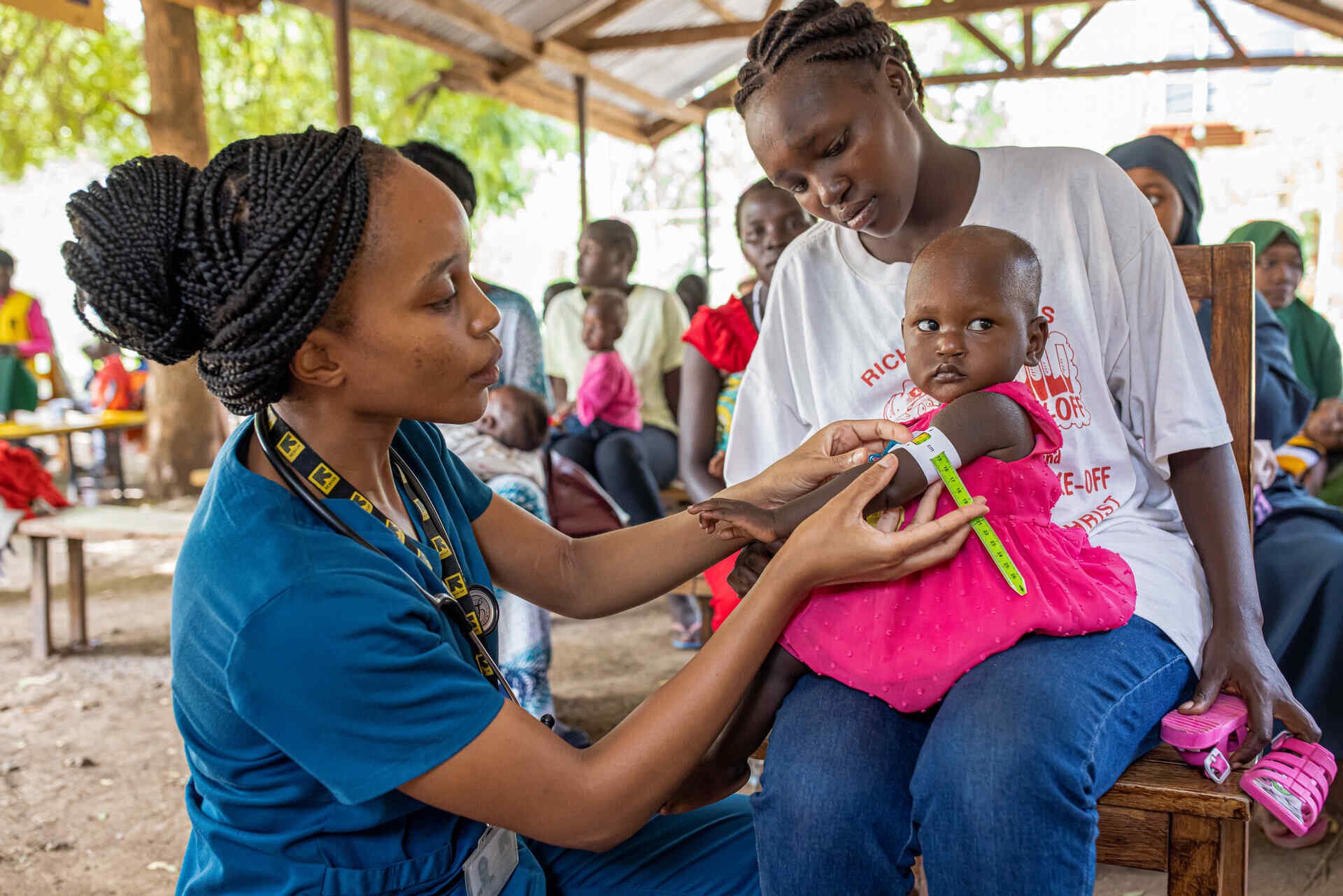 Dr. Sila Monthe, 29, health manager for IRC at Kakuma, checks client for malnutrition at Locher Angamor Health Dispensary in Kakuma Refugee Camp.