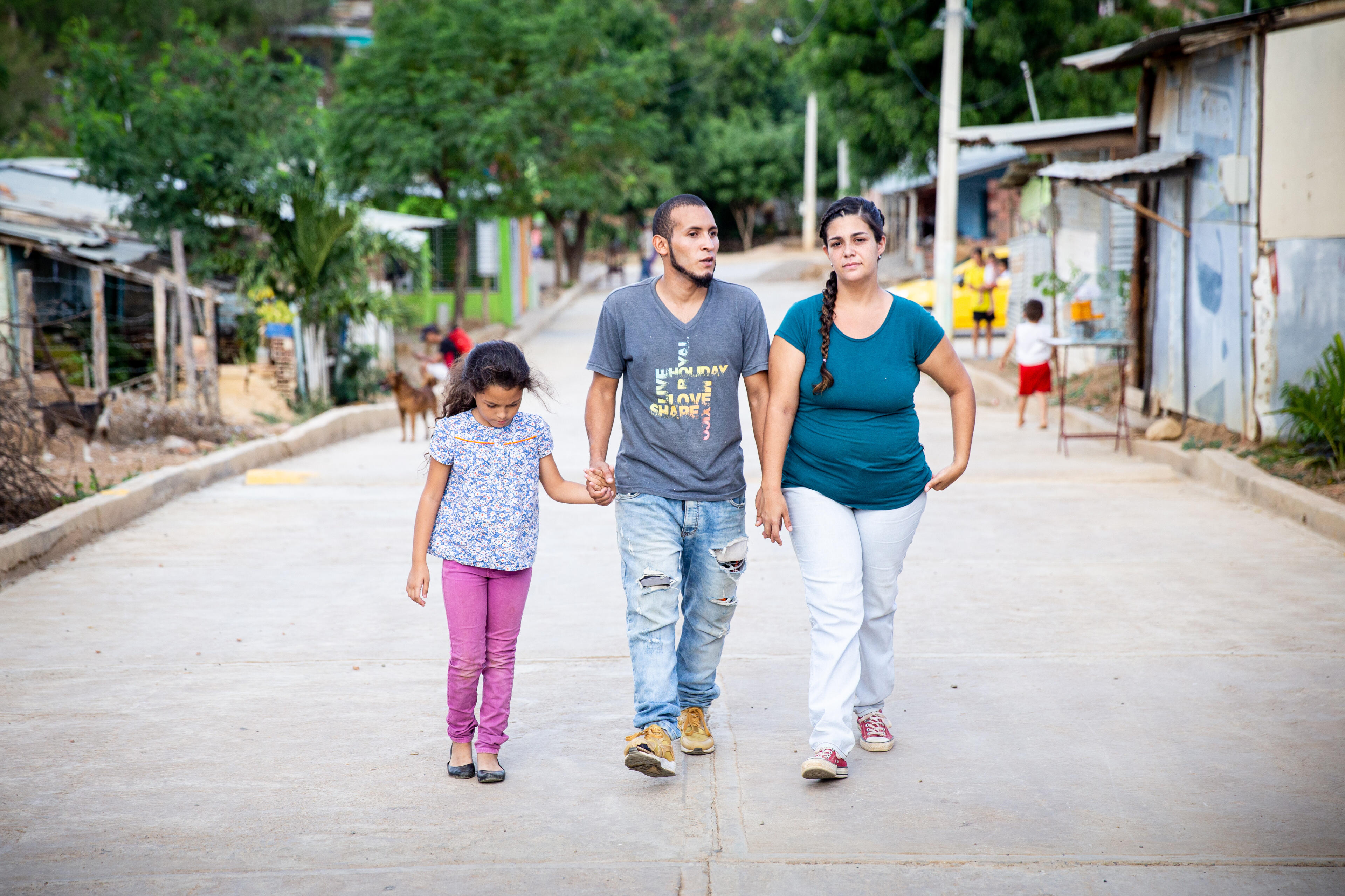 Andrea and her family, who left Venezuela, walk near their new home in Cucuta, Colombia.