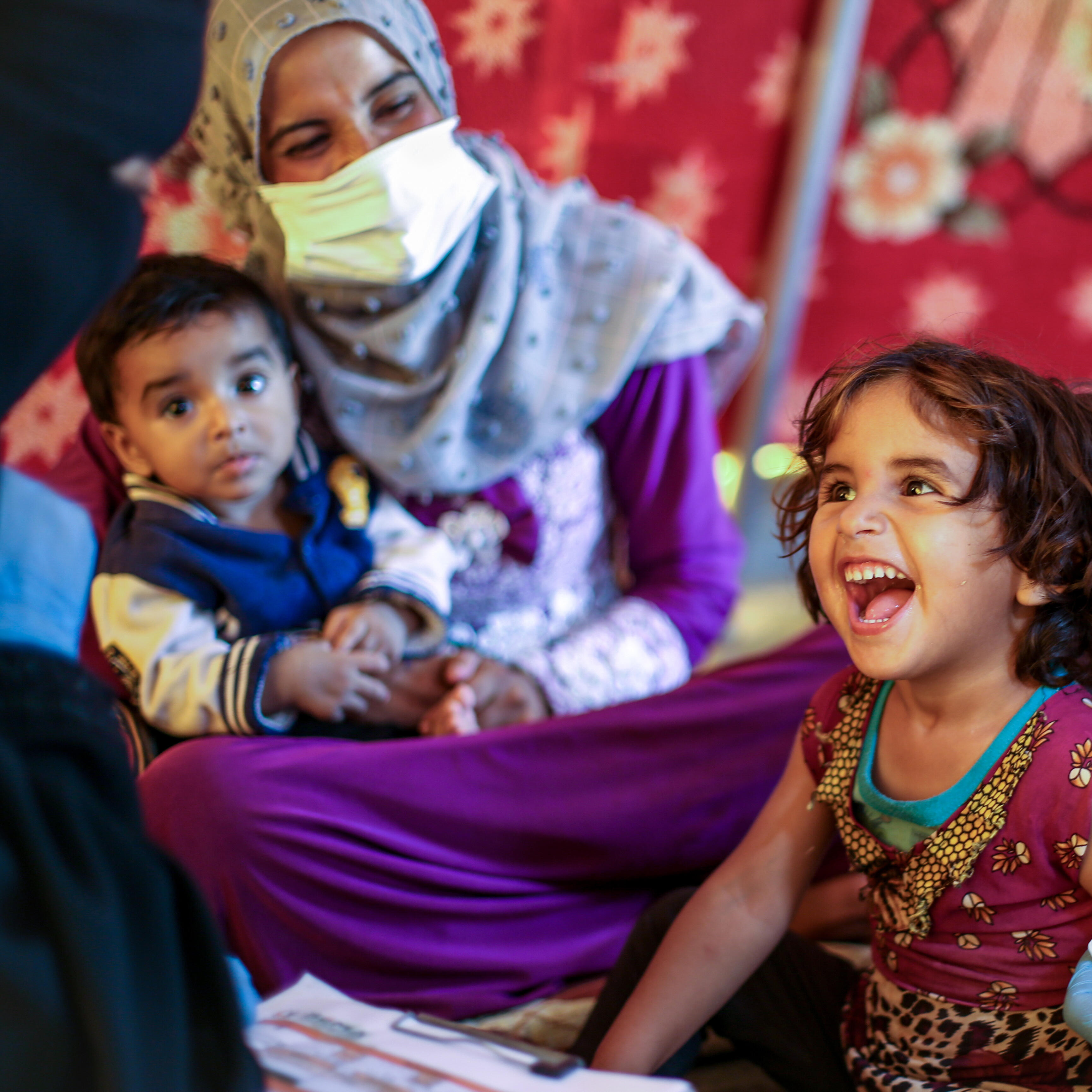 An IRC health care team tests a young girl in Syria for malnutrition.