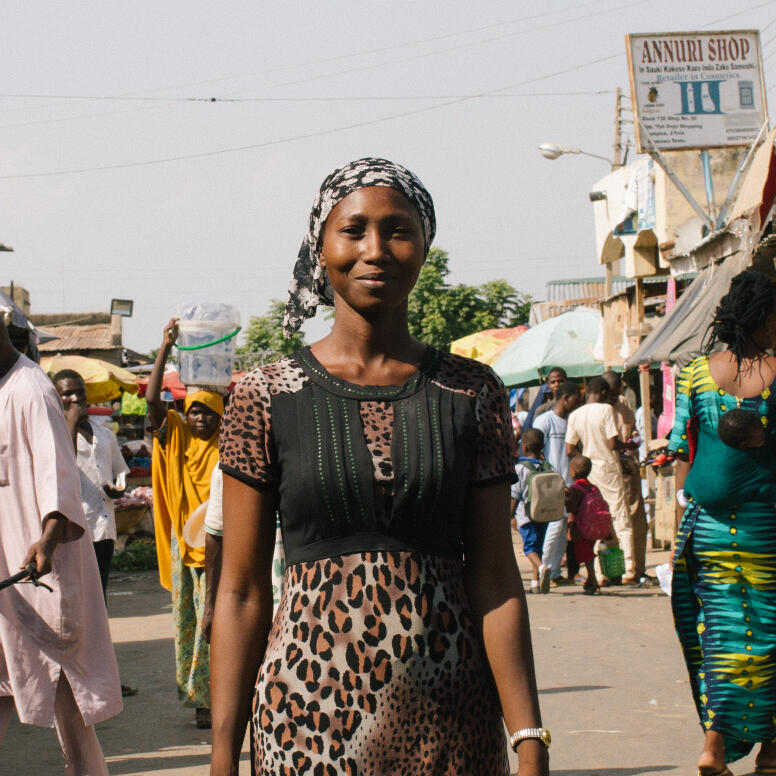 Lydia walking in a market.