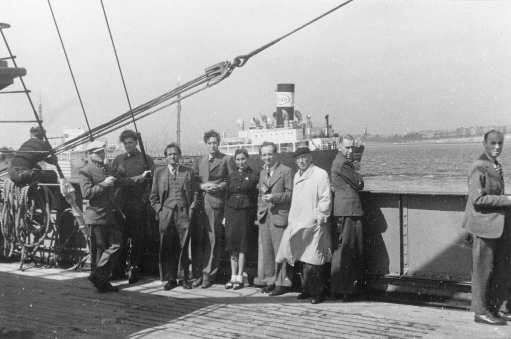 European refugees stand facing the camera, on board converted cargo ship sailing from Marseilles to Martinique, March 25, 1941. 