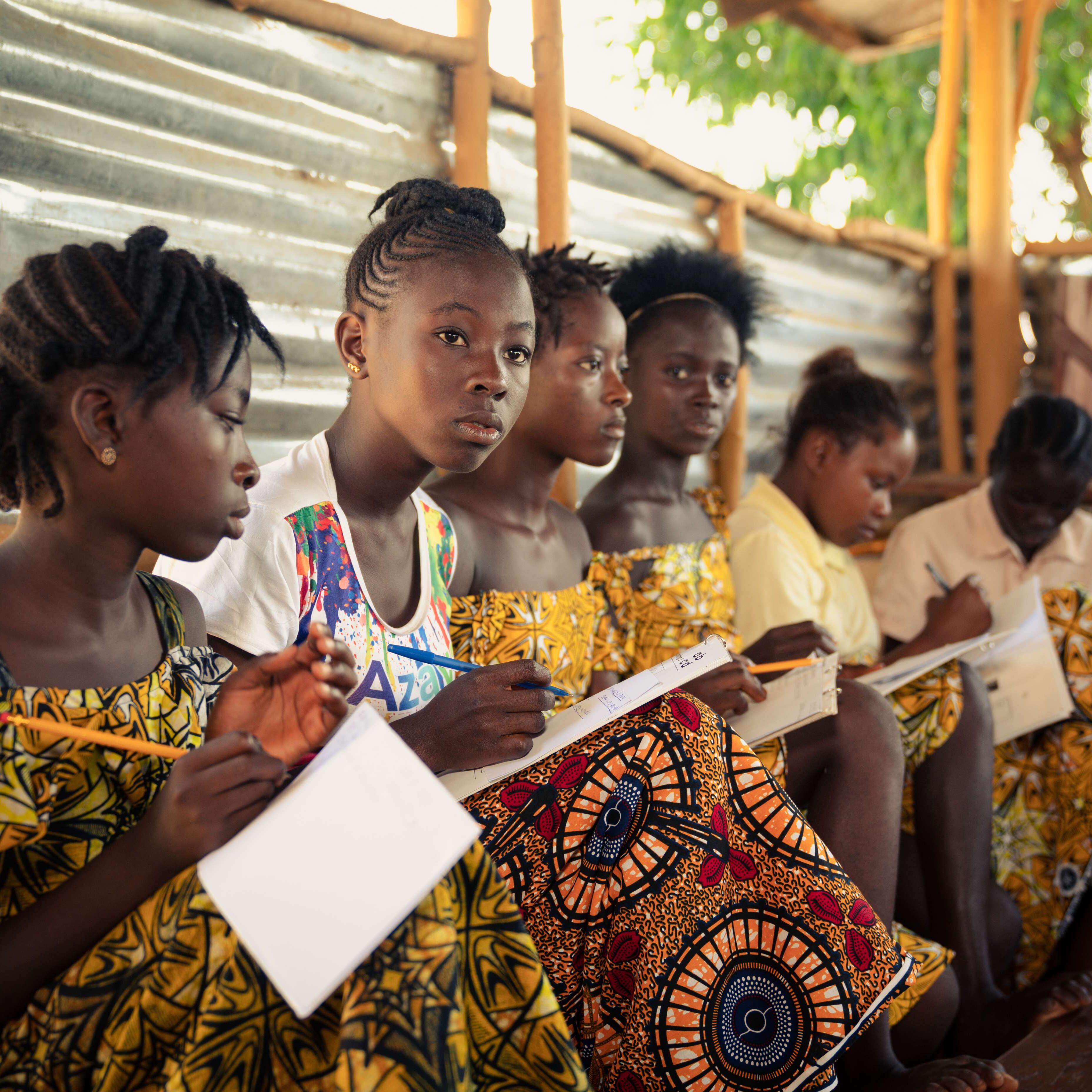 A group of children reading at class during the EAGER project.