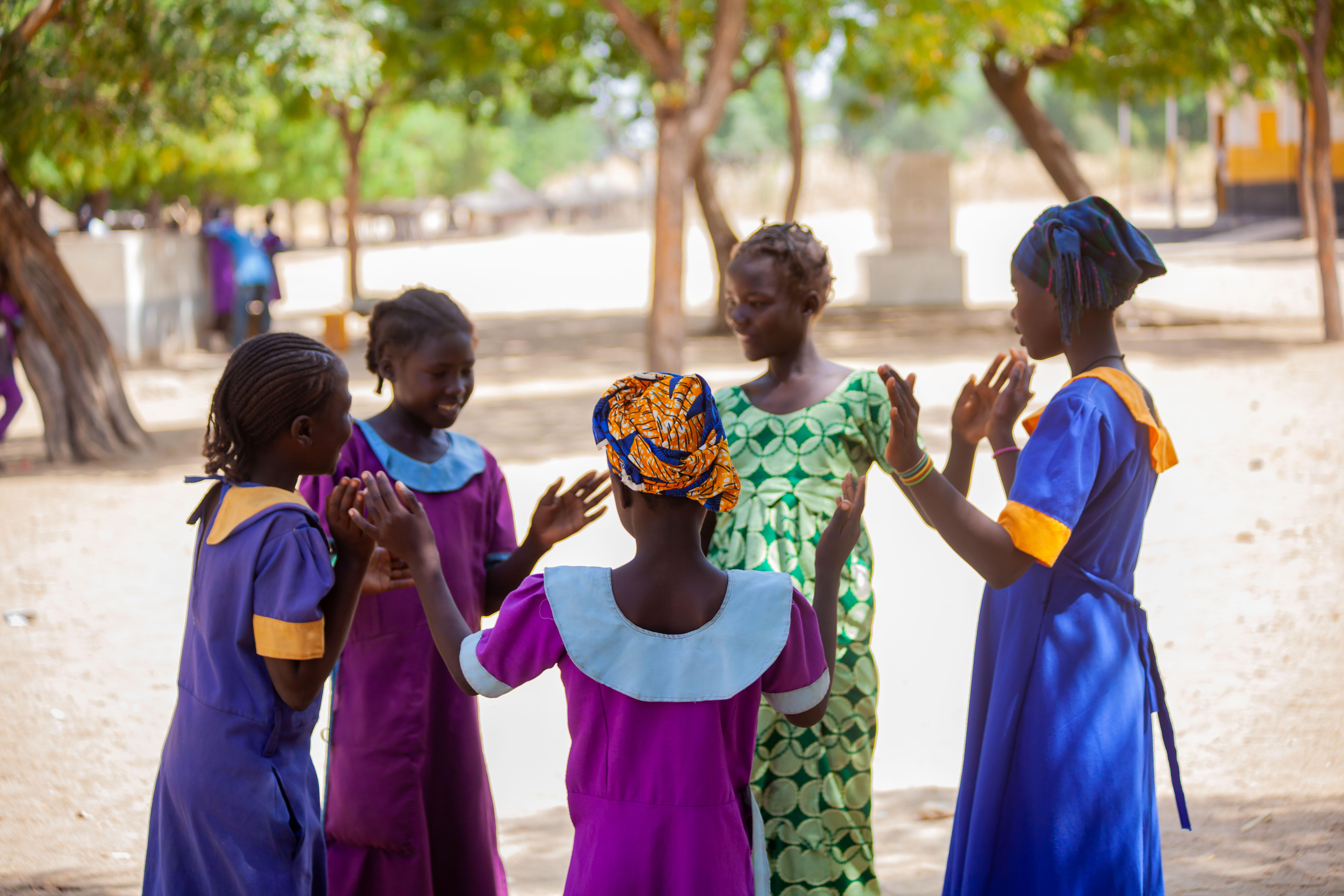 Oudjila, Cameroon. Wedé Clémautine, 12, Asta Julienne, 14 and some of their classmates having fun in the school playground.