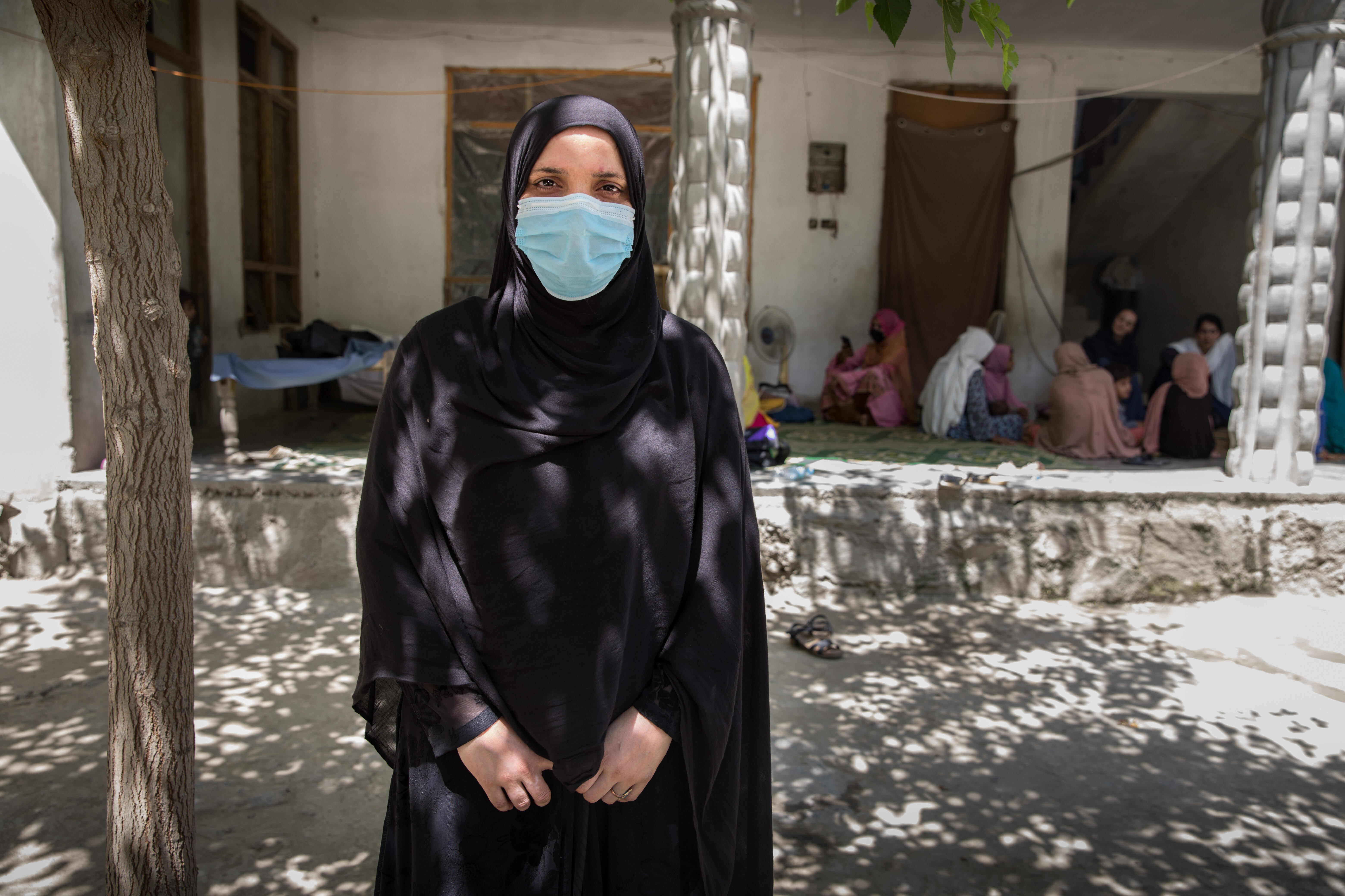 Mariam*, a 24-year-old Afghan health worker, poses for a portrait after giving a cooking class and nutrition recommandations to her community.