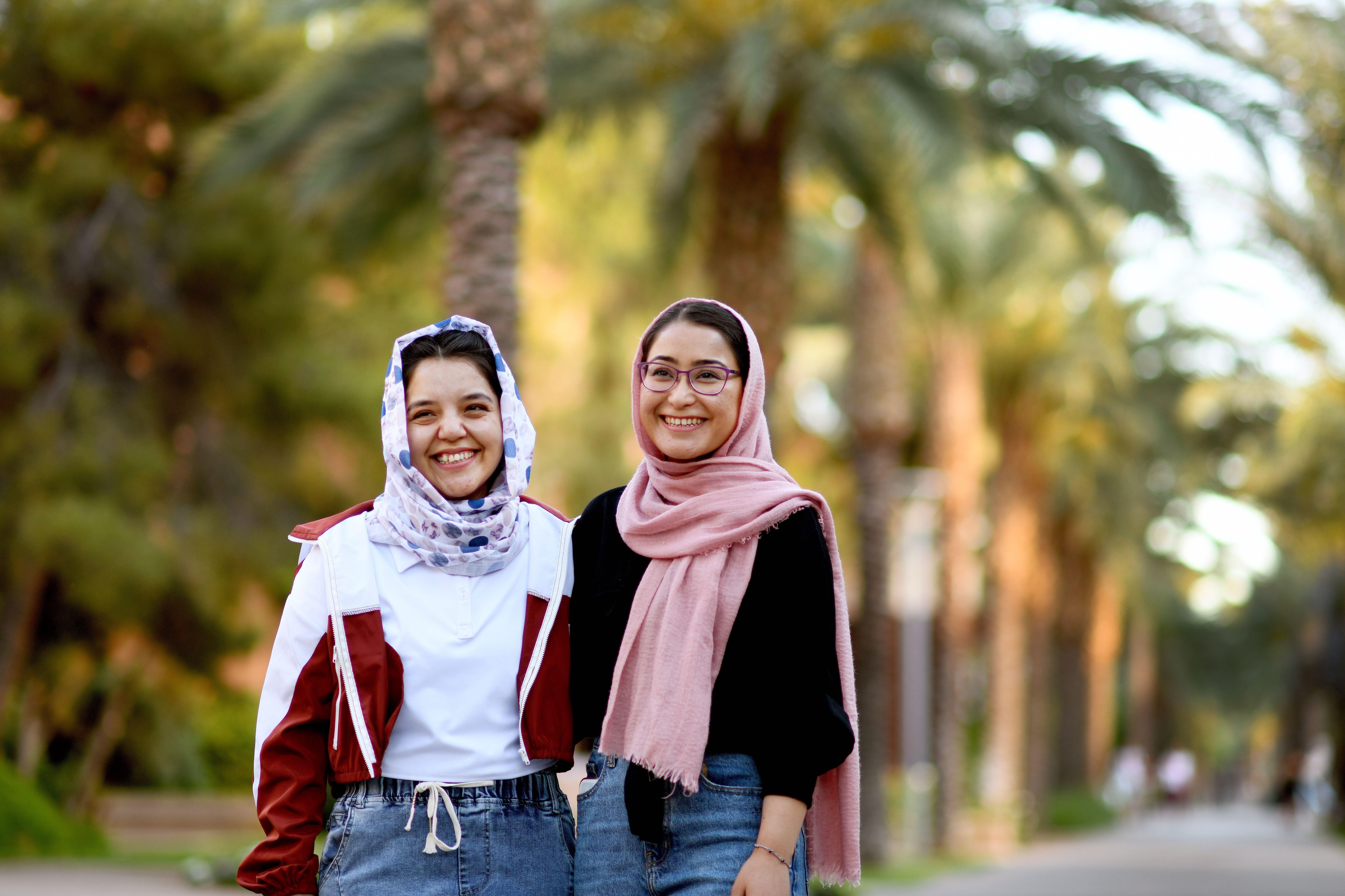 ASU Afghan scholars stand together at the Palm Walk on campus.