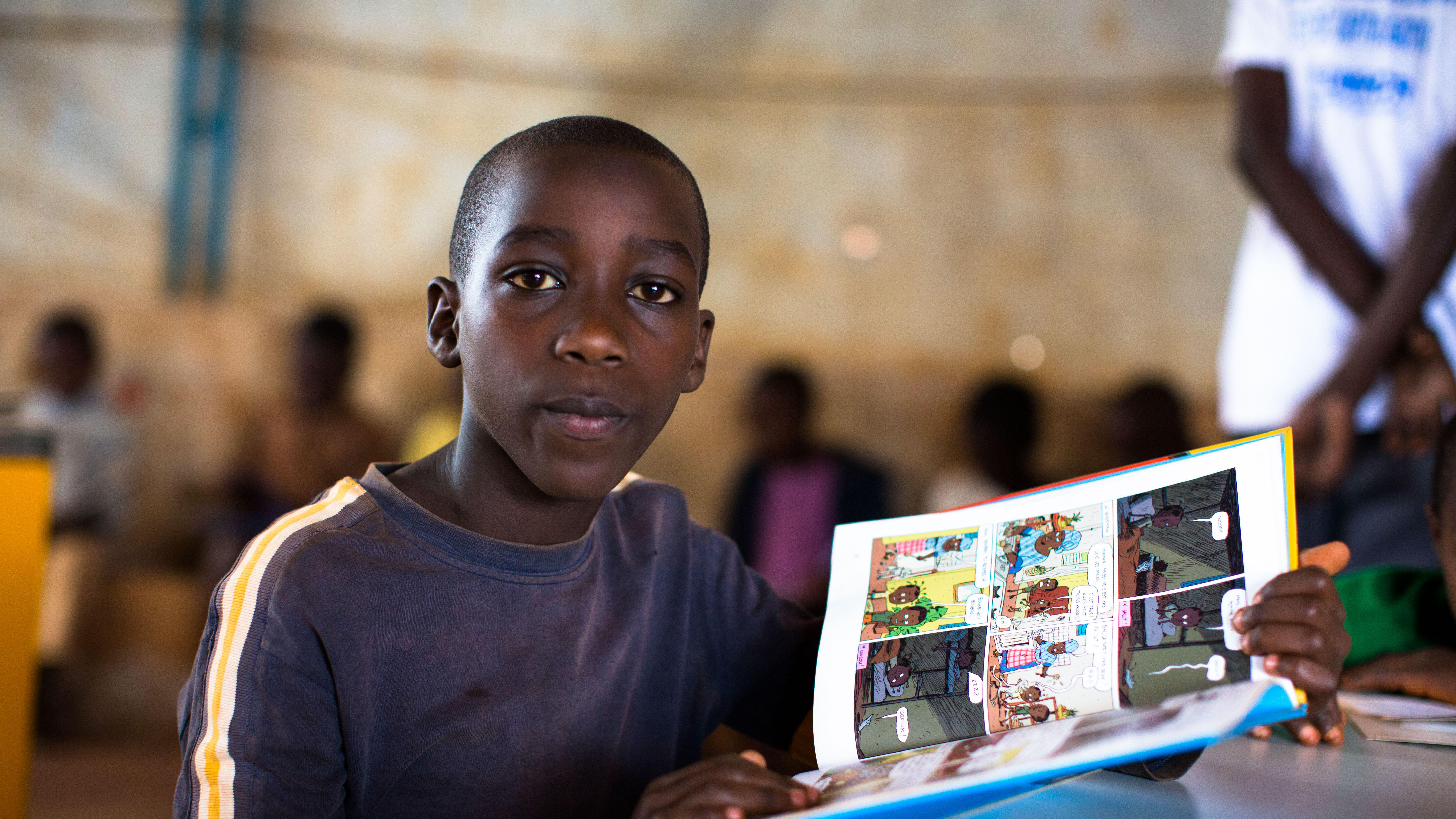 A student reads in a classroom in Burundi.