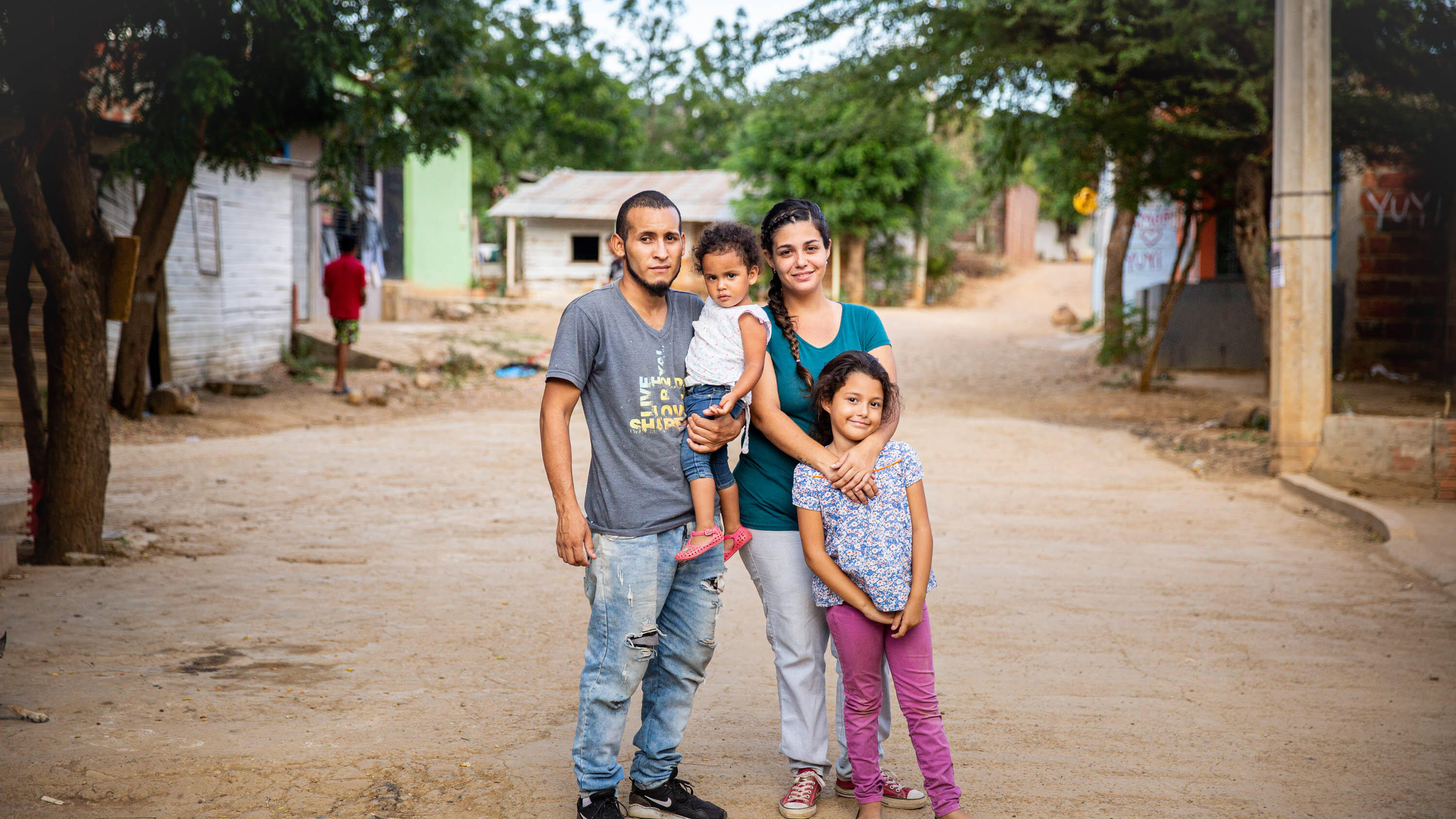 A family stop in the road to pose for a picture.