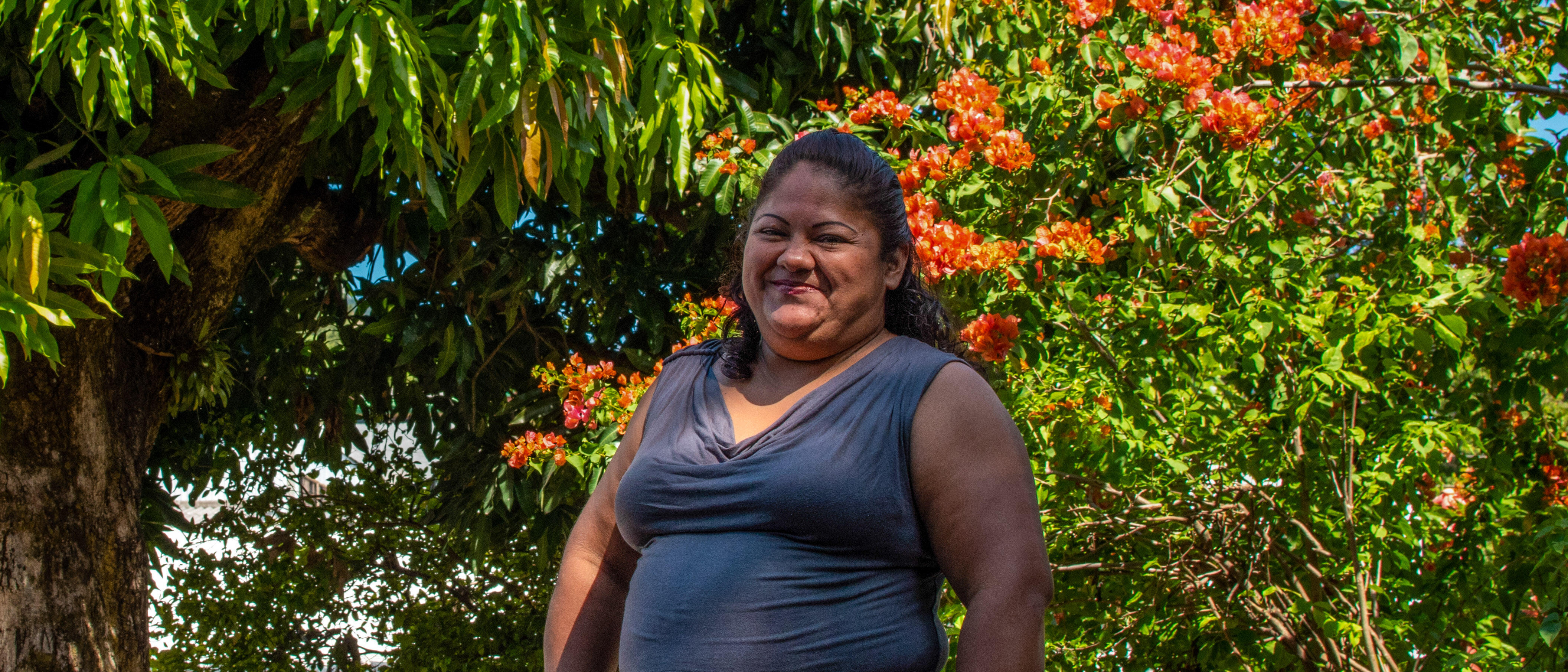 A woman poses for a portrait outside in El Salvador.