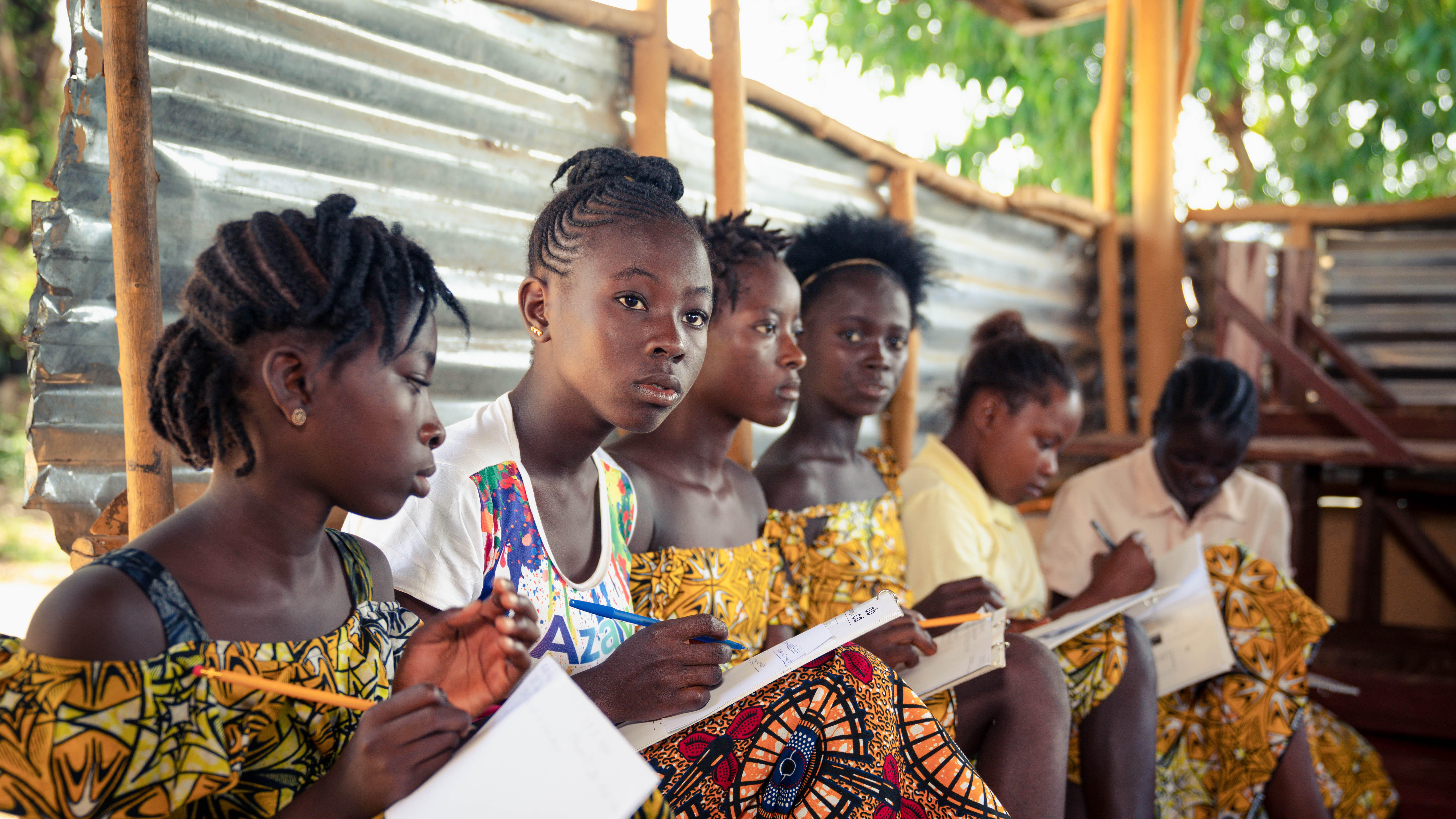 A group of girls in Sierra Leone attend an IRC workshop.