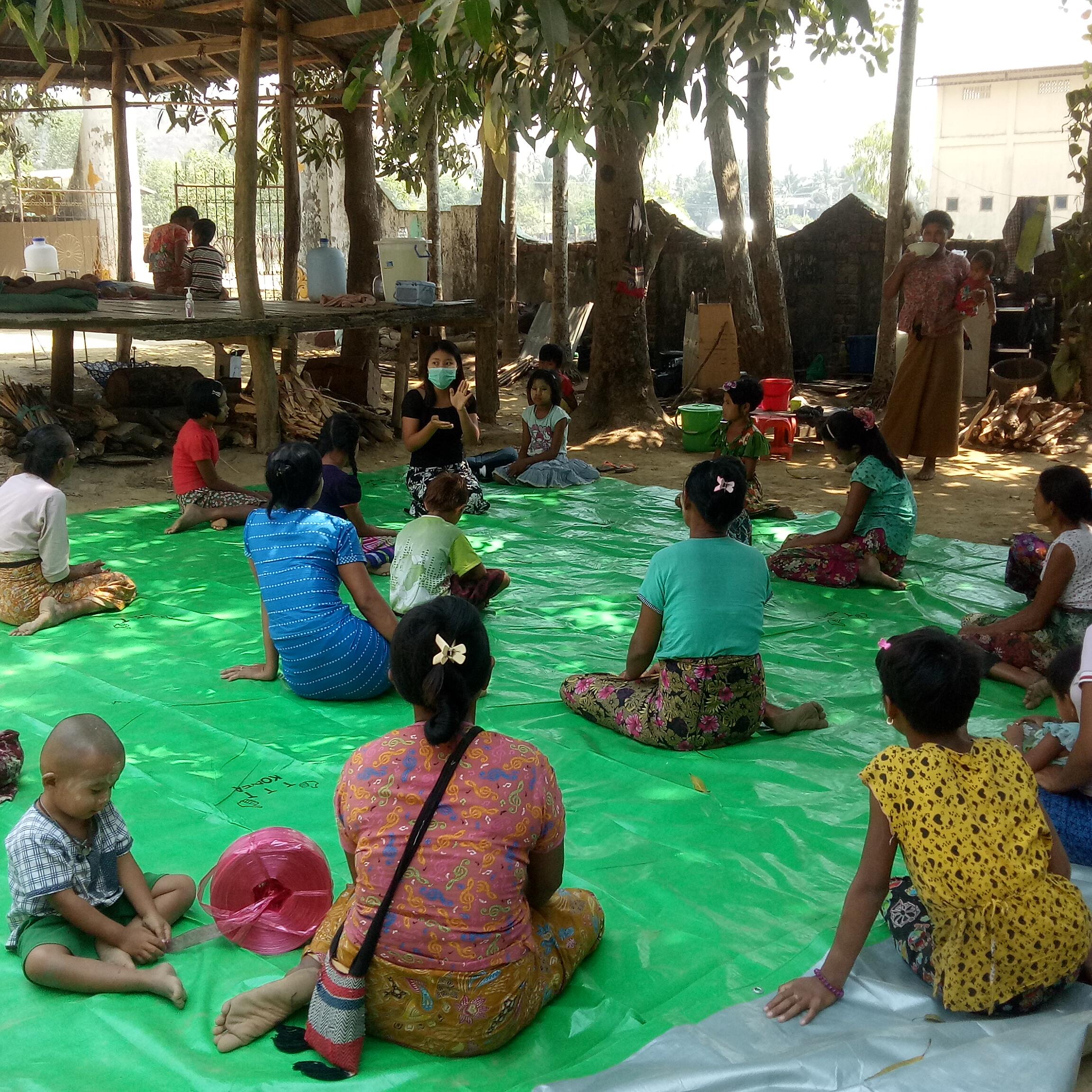 IRC mobile health team carrying out an education session for refugees outside