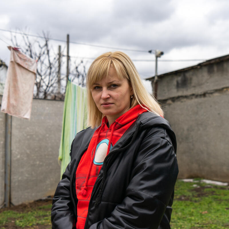 Tetiana standing in front of a clothes line full of laundry