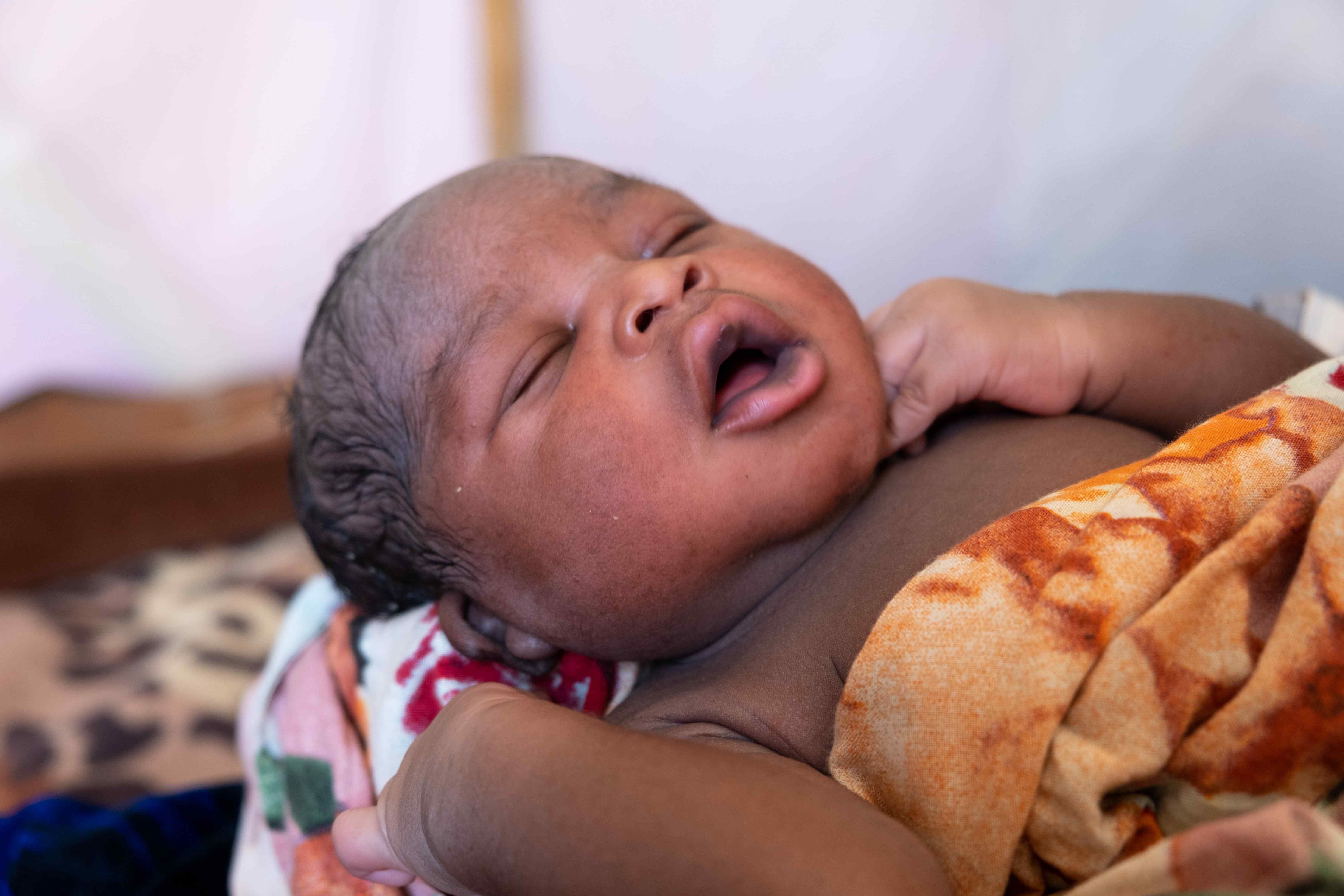 30 May 2023. Gaga refugee camp, Chad. Raouda’s baby, Abdelrahim, is born a few hours earlier in the IRC's health center.