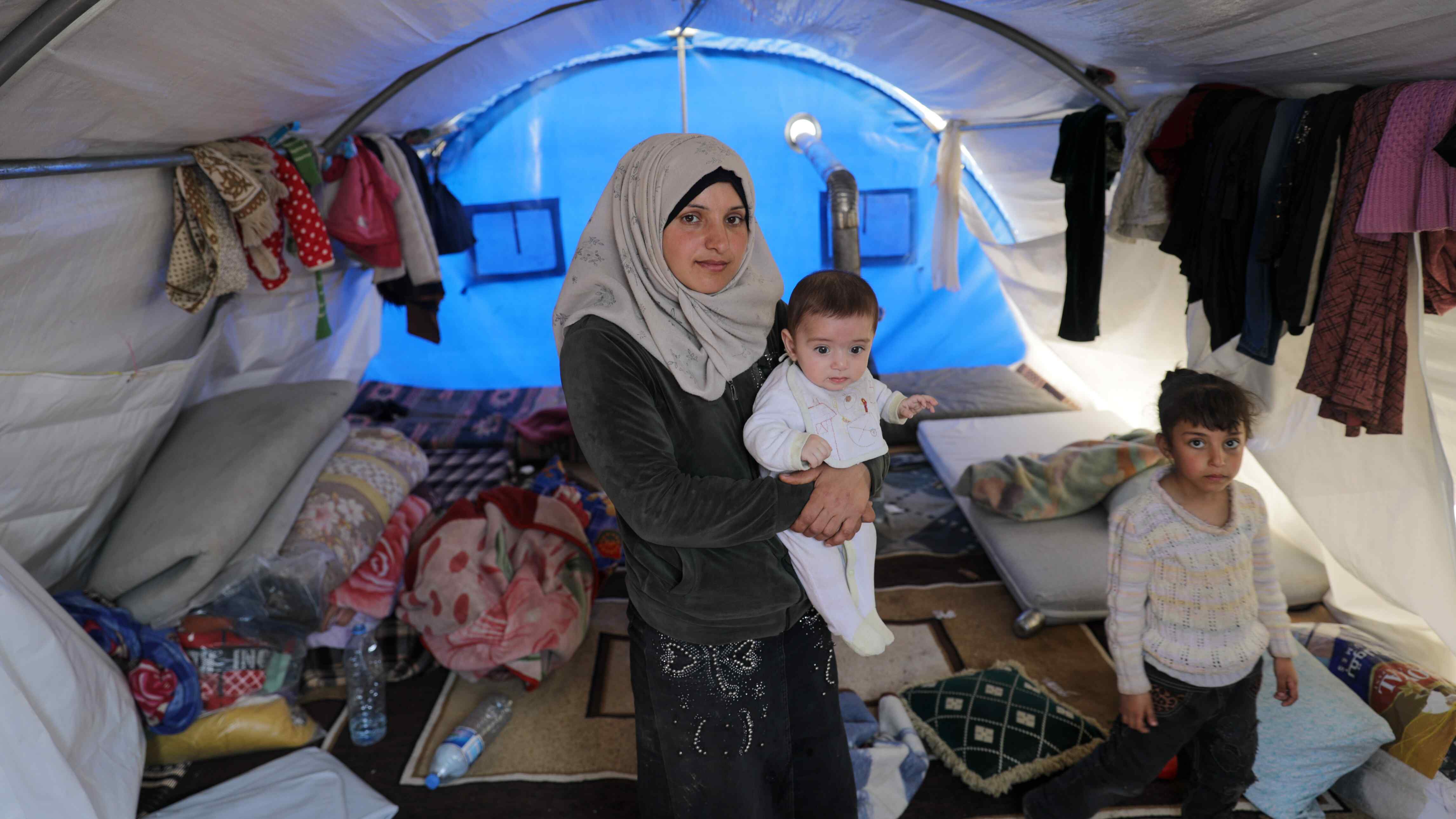 A mother holds her child at a shelter in Syria.