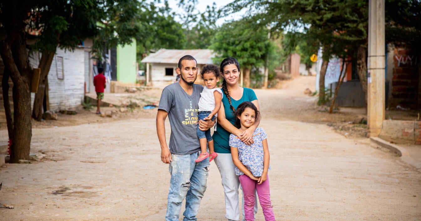 A family stands in the middle of a road