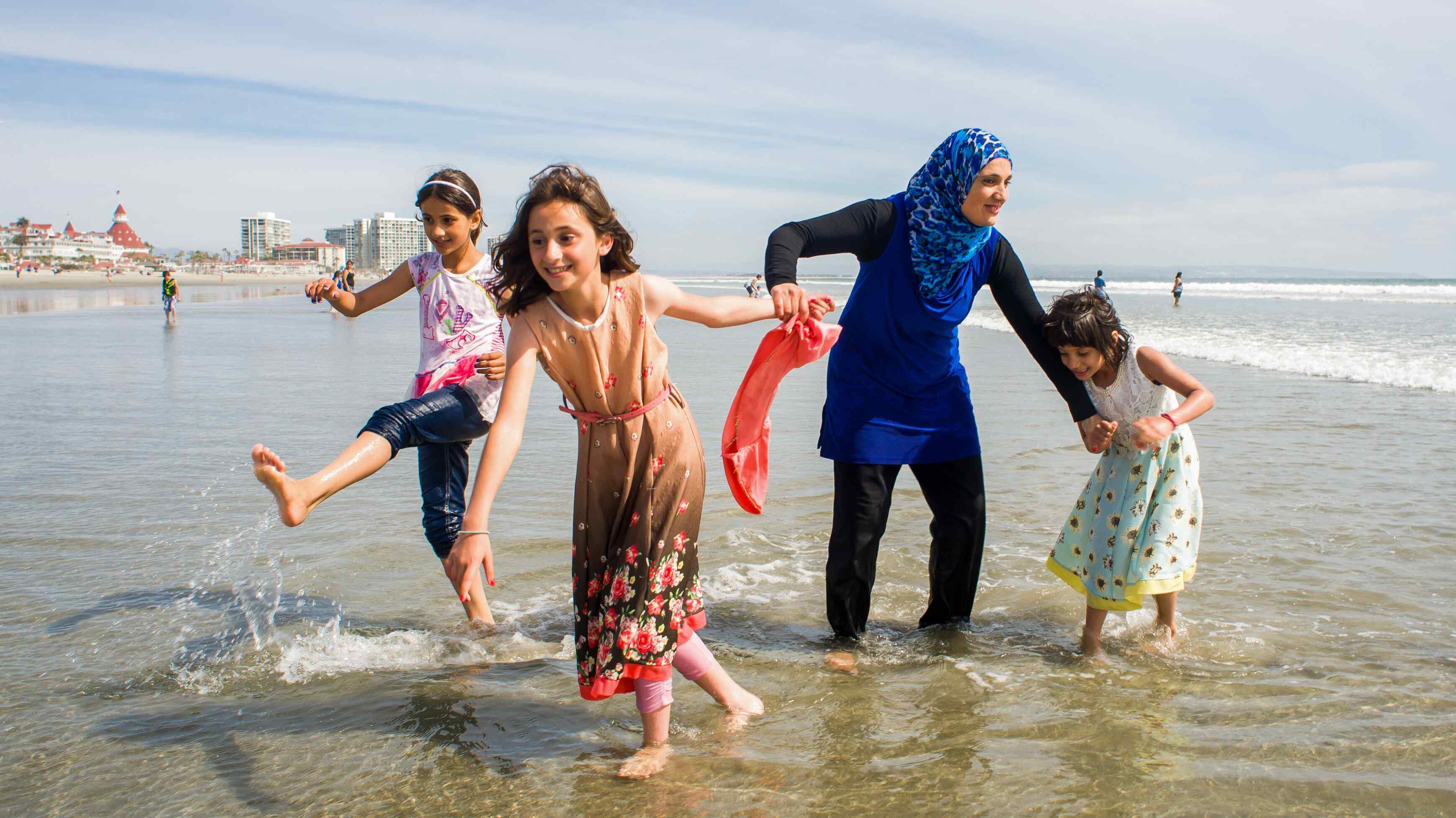 A family plays on the beach.