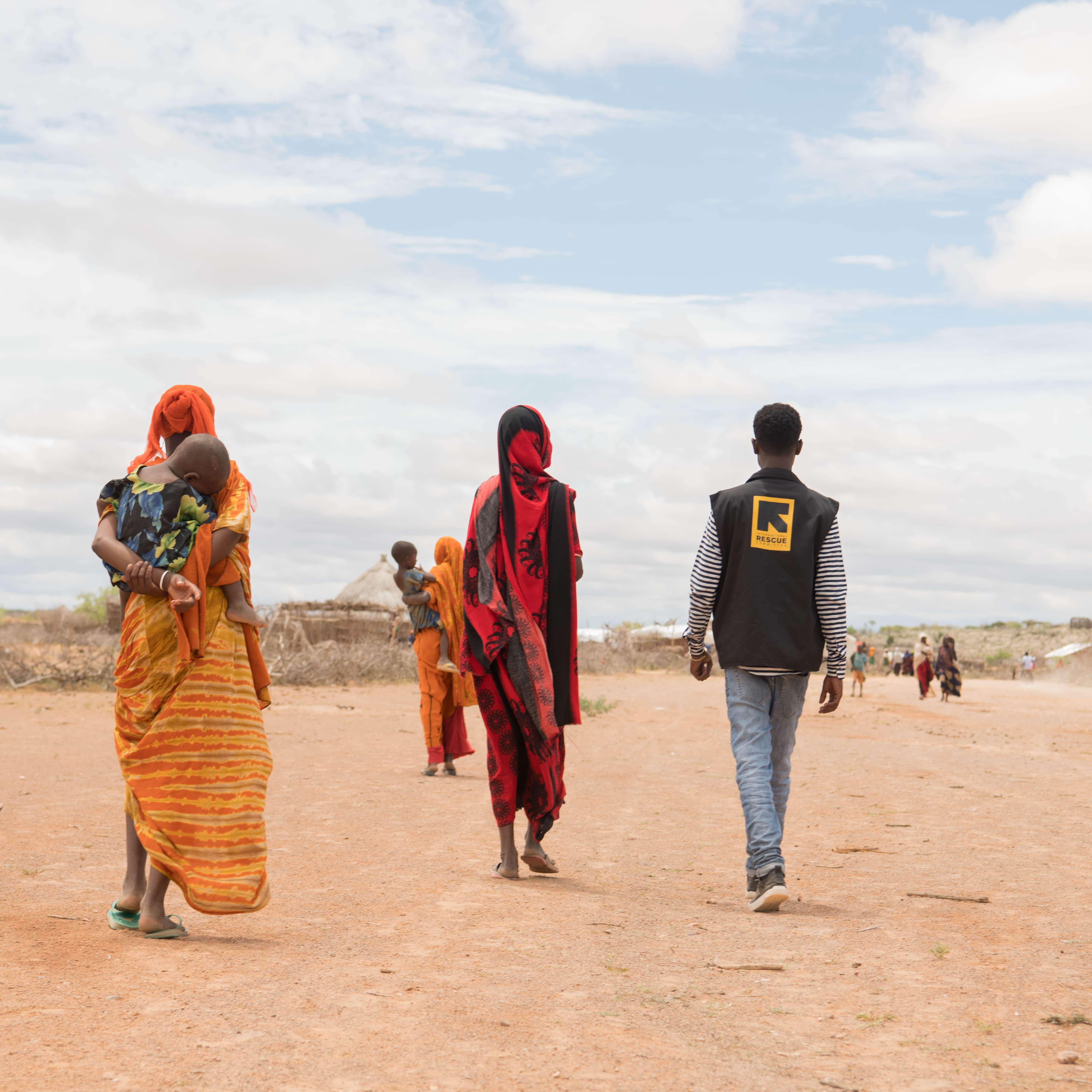 May 23, 2023 - Qudha'ale IDP camp, East Imi District, Ethiopia. An IRC staff walks with Asay Kurba,38, and other women in the camp to the former's home in Qudha'ale IDP camp. IDP women are seen walking in Qudha'ale IDP camp.