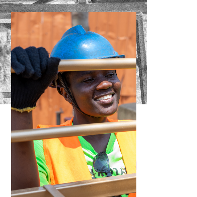 Rahma smiling wearing a construction uniform