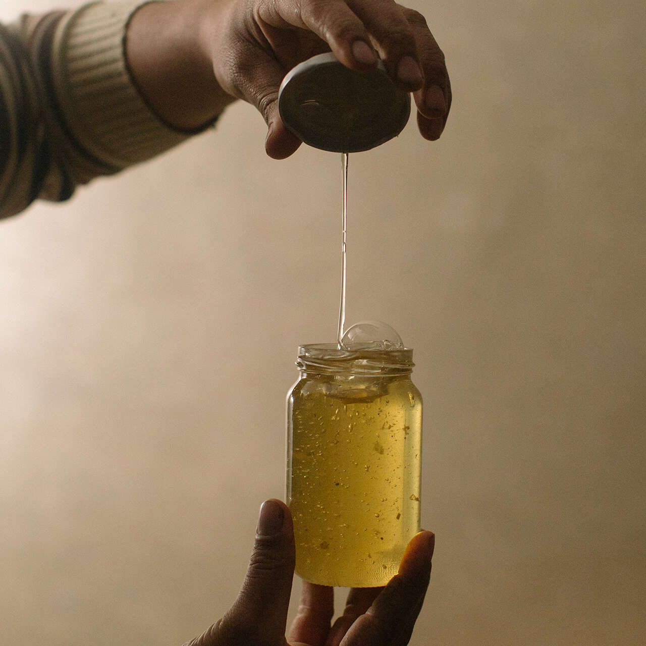 Huthaifa holding a jar of honey 