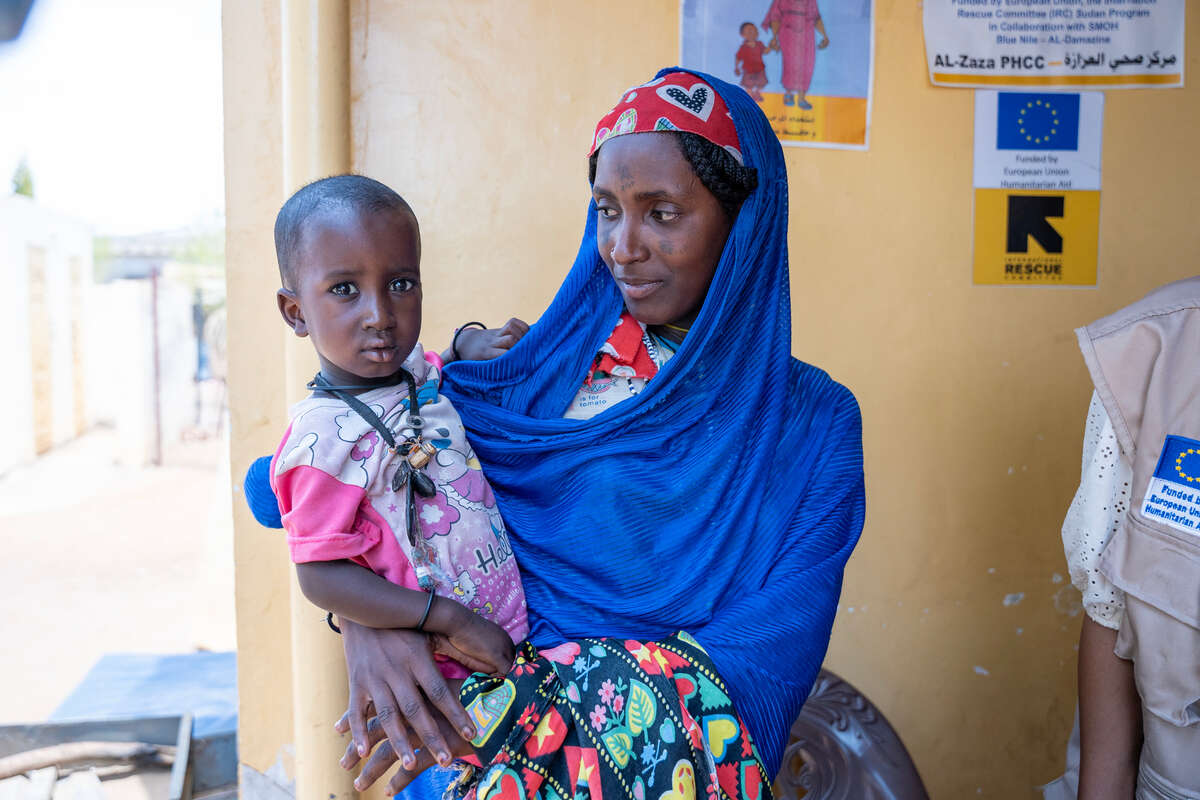 Zeinab’s mother looks at her with care 