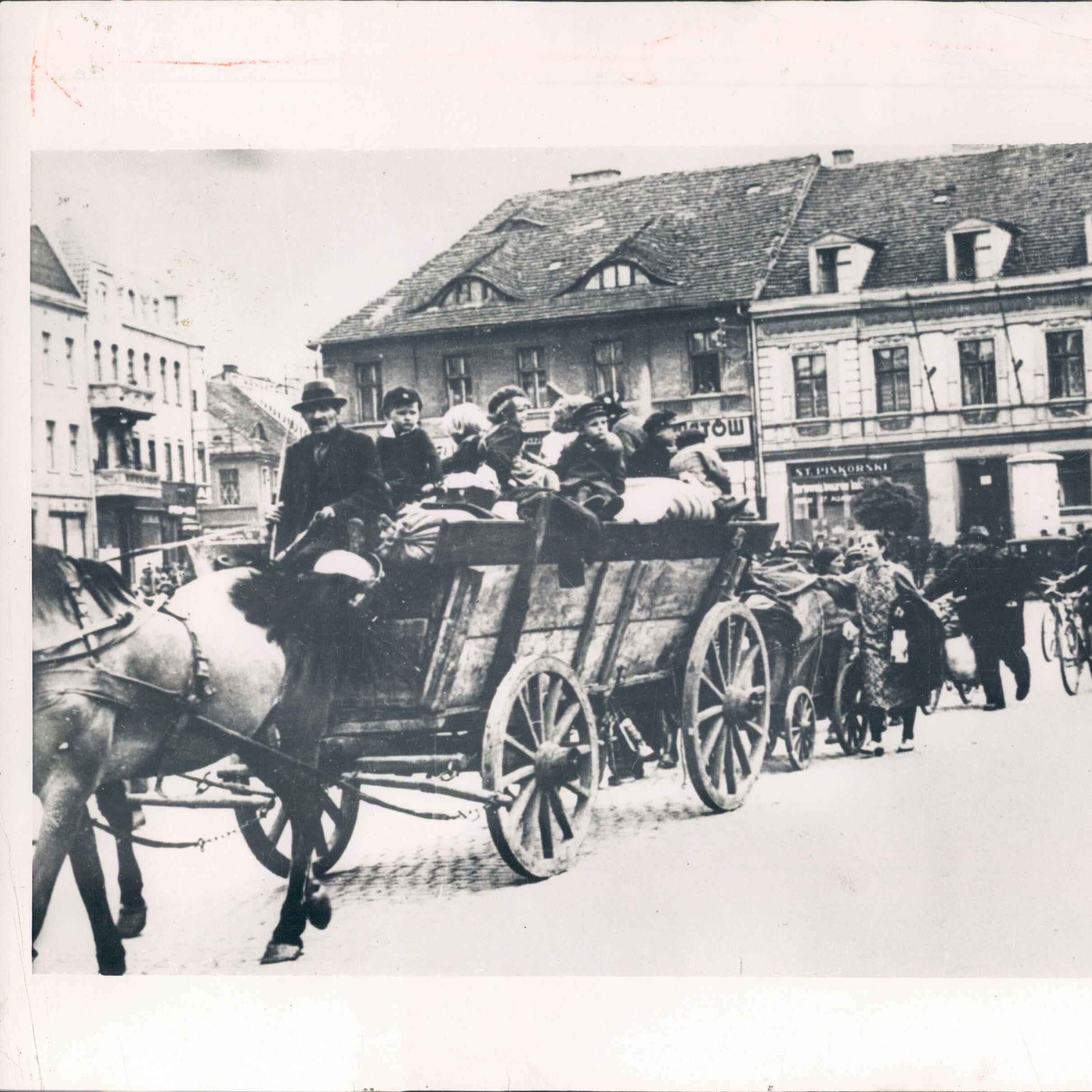 Polish refugees ride in a horse-drawn wagon with their belongings 