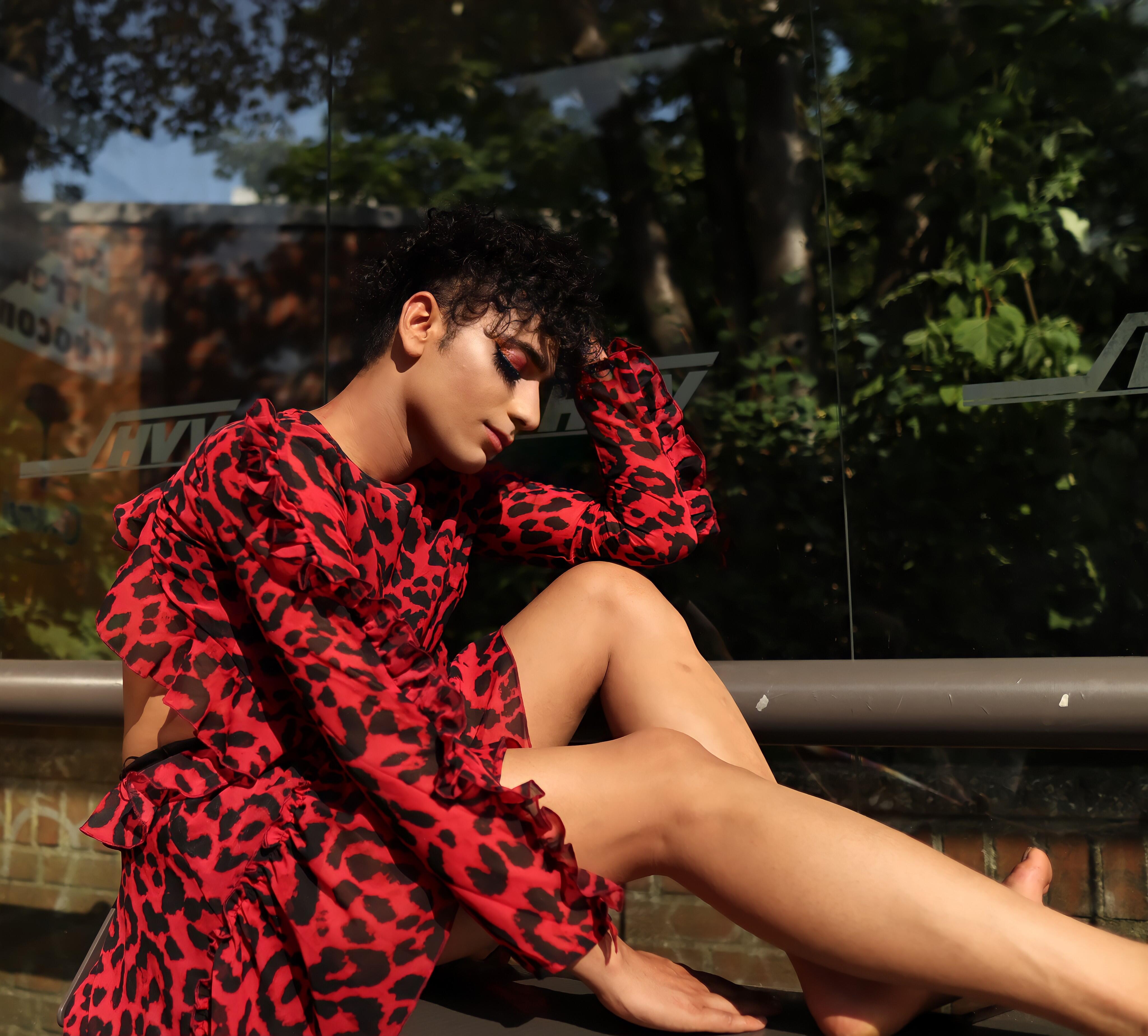 Najib Faizi dressed in a red dress