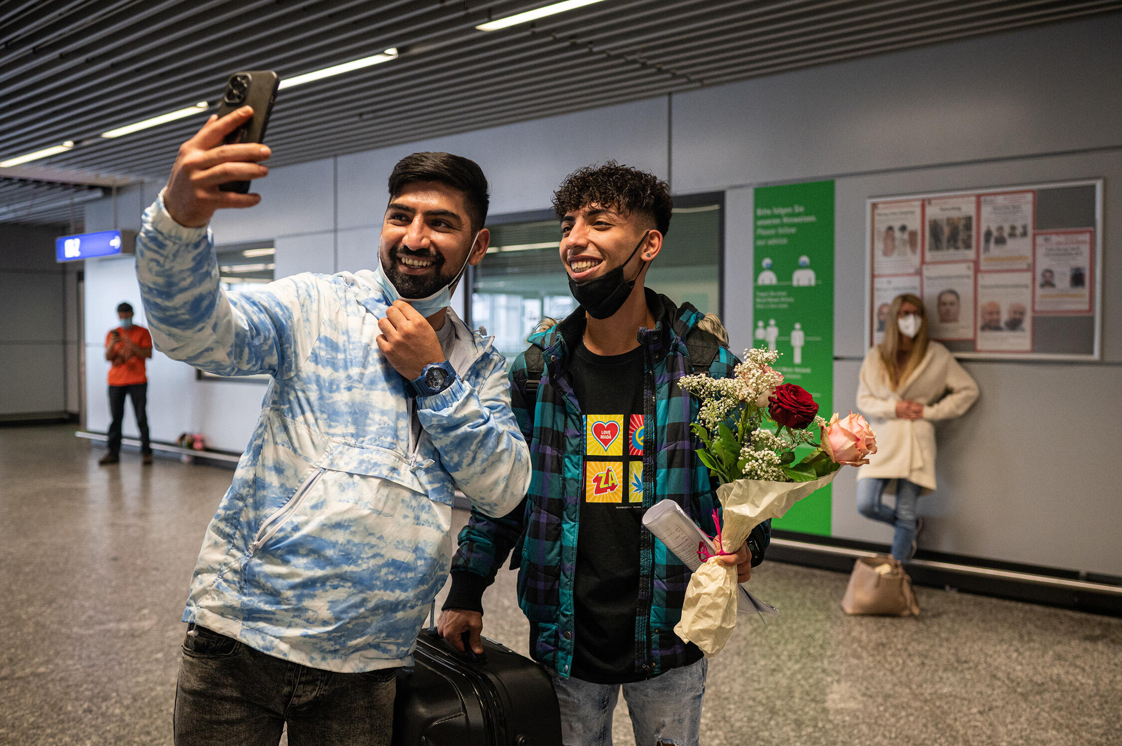 Brothers Ali and Mehdi take a selfie together at the airport.  