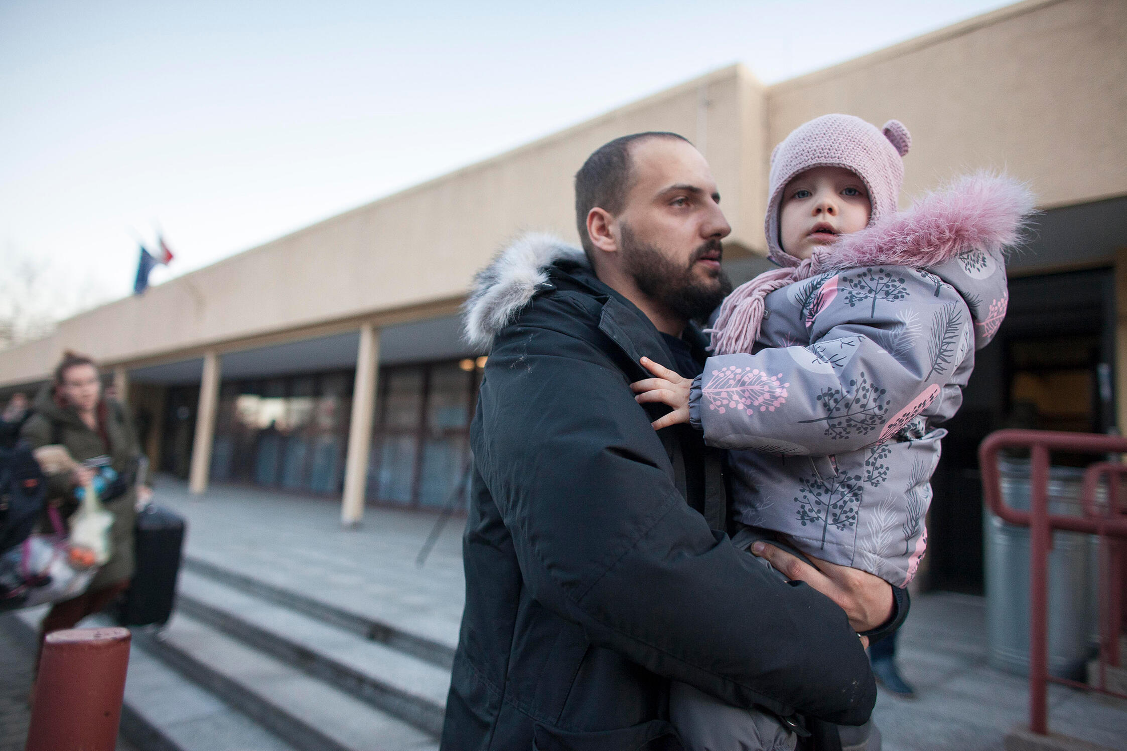 A man holds his child as par of the first train of refugees arriving in Poland.