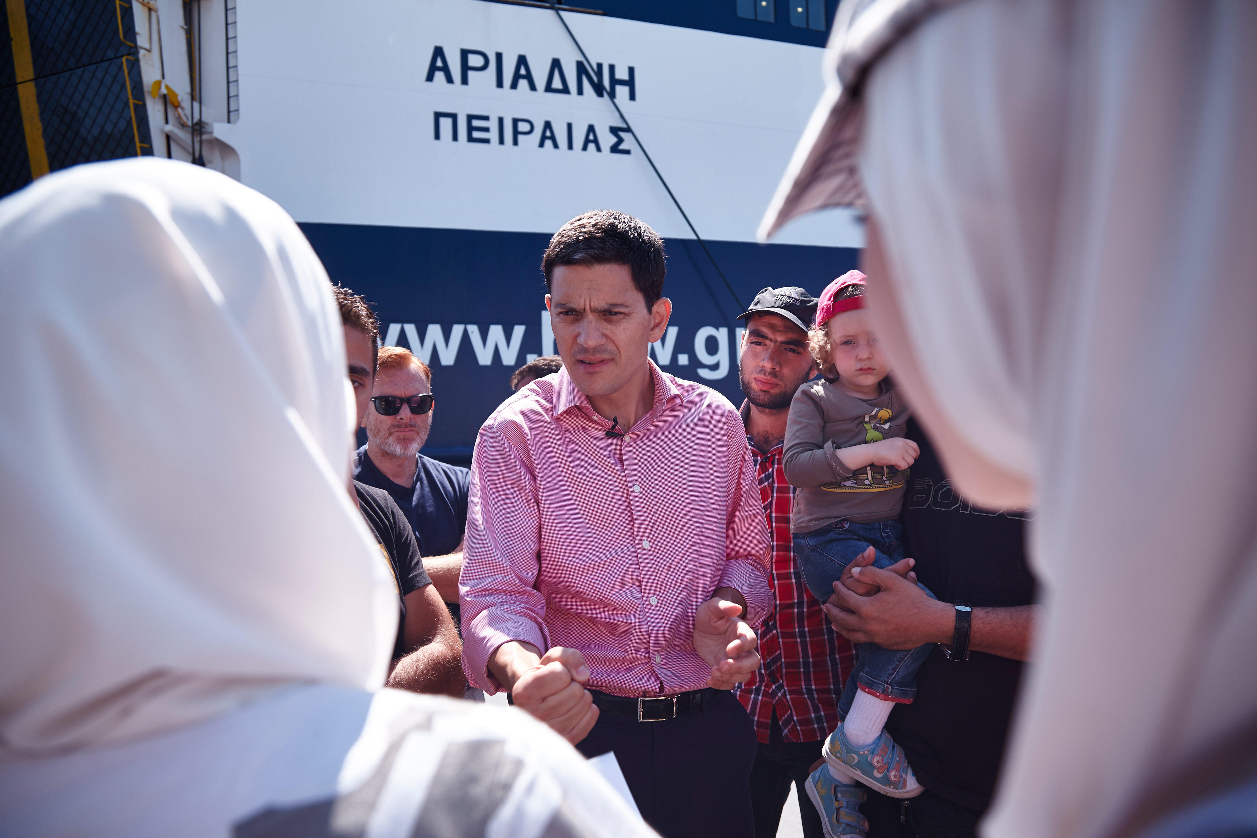 David Miliband in red shirt talking to a crowd