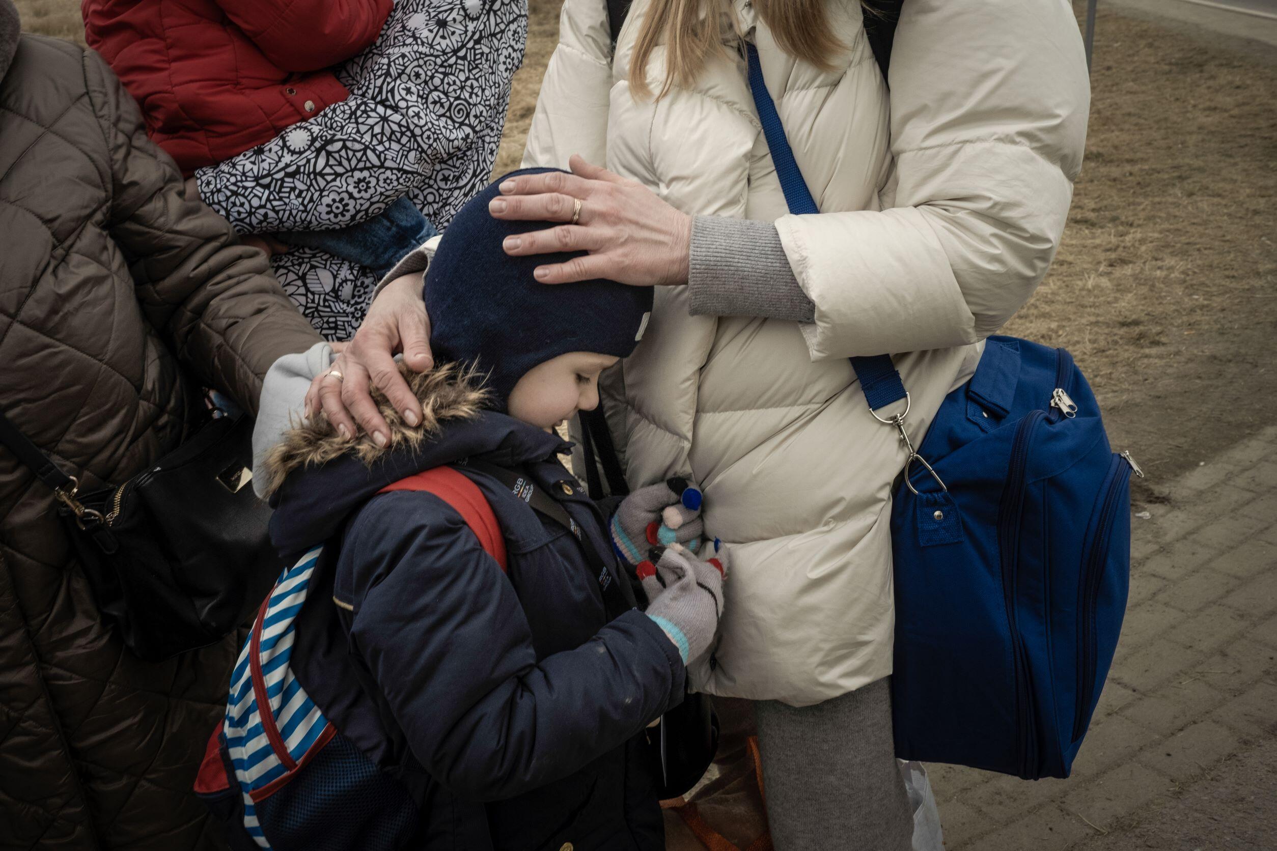 A refugee woman comforts her child