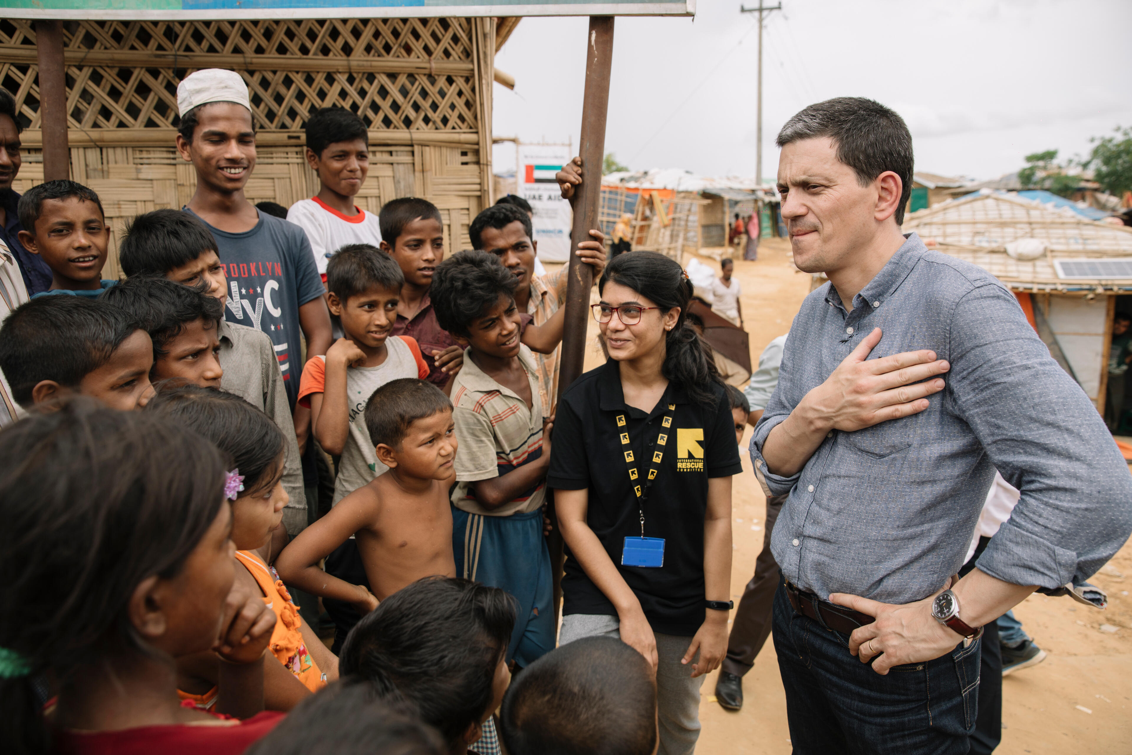 David Miliband places his hand on his heart as he stands speaking with Rohingya refugees in a camp in Bangladesh.