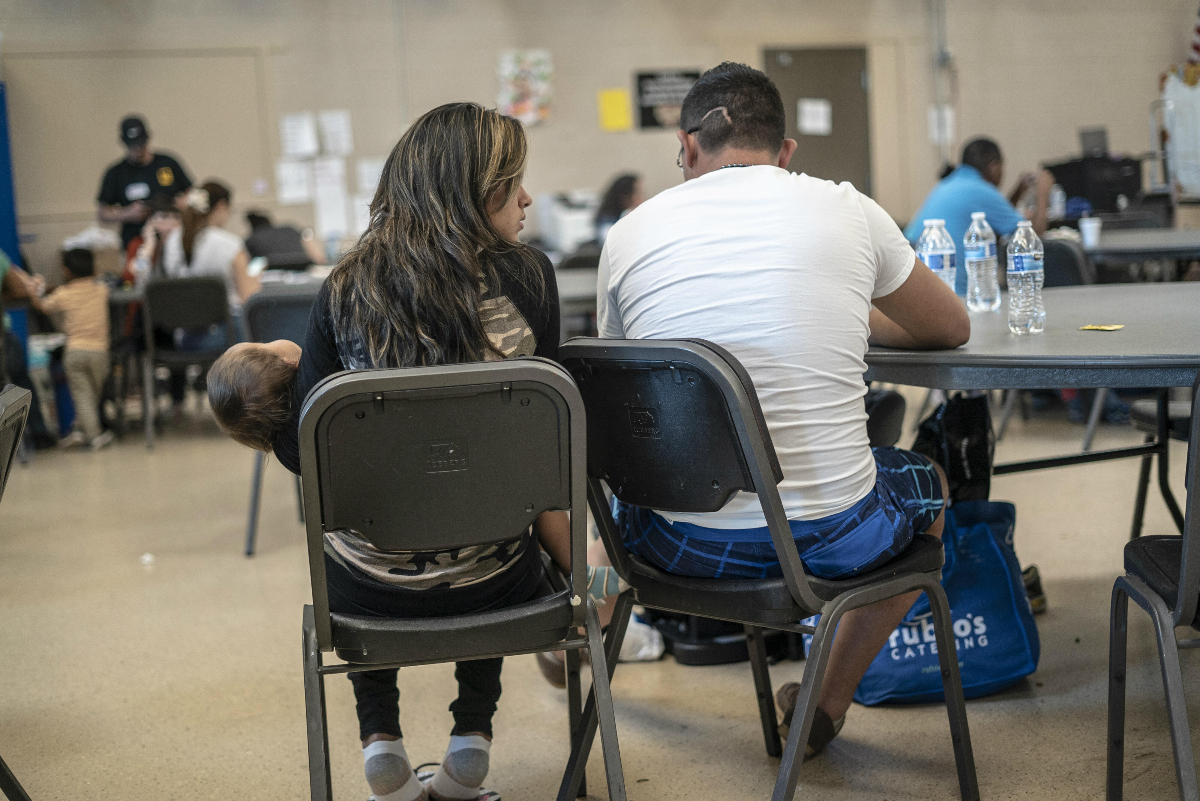 Man, woman and baby from Central America at an IRC day center for asylum seeker sin Phoenix, Ariz.