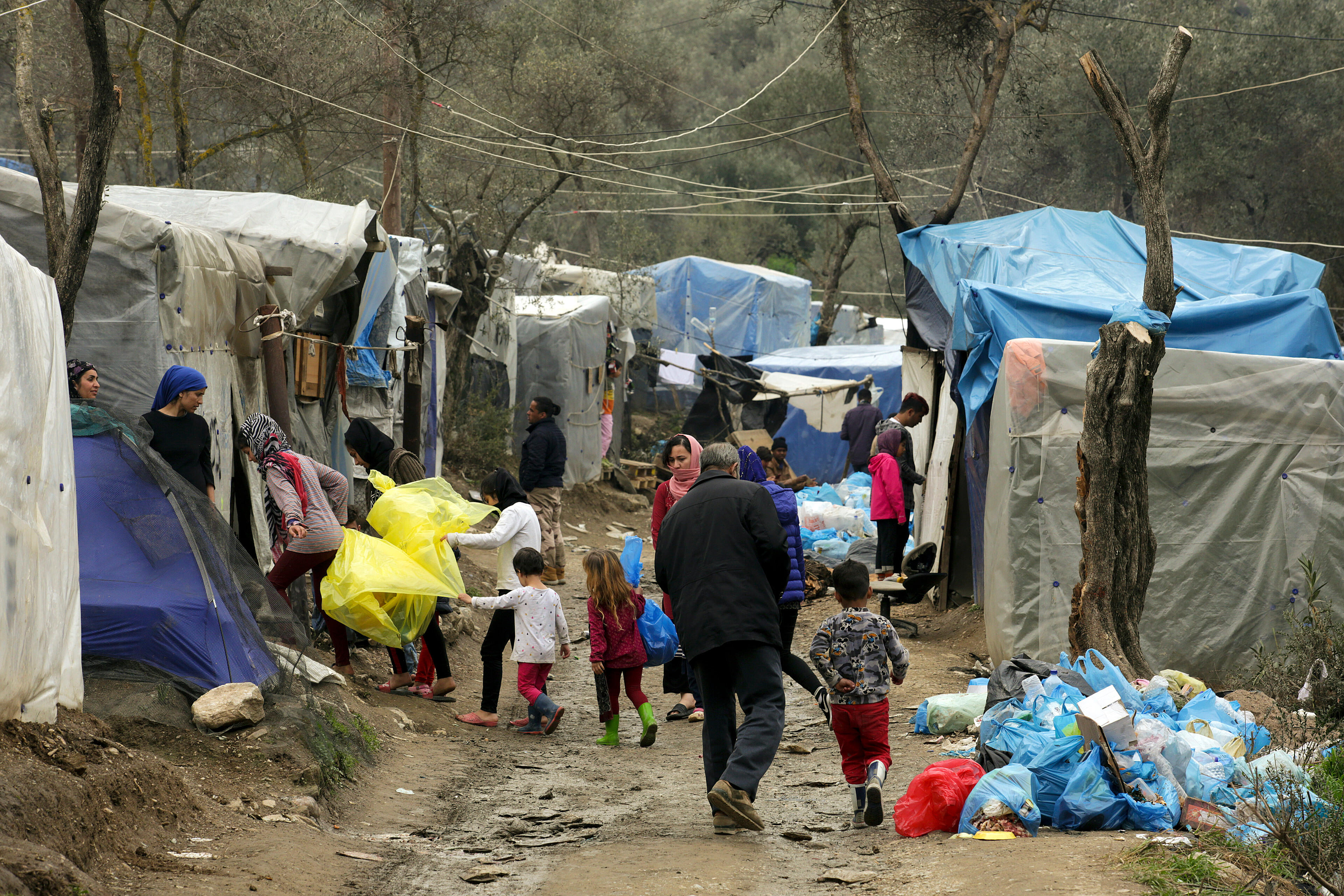 People walk between the crowded rows of tents in Moria refugee camp