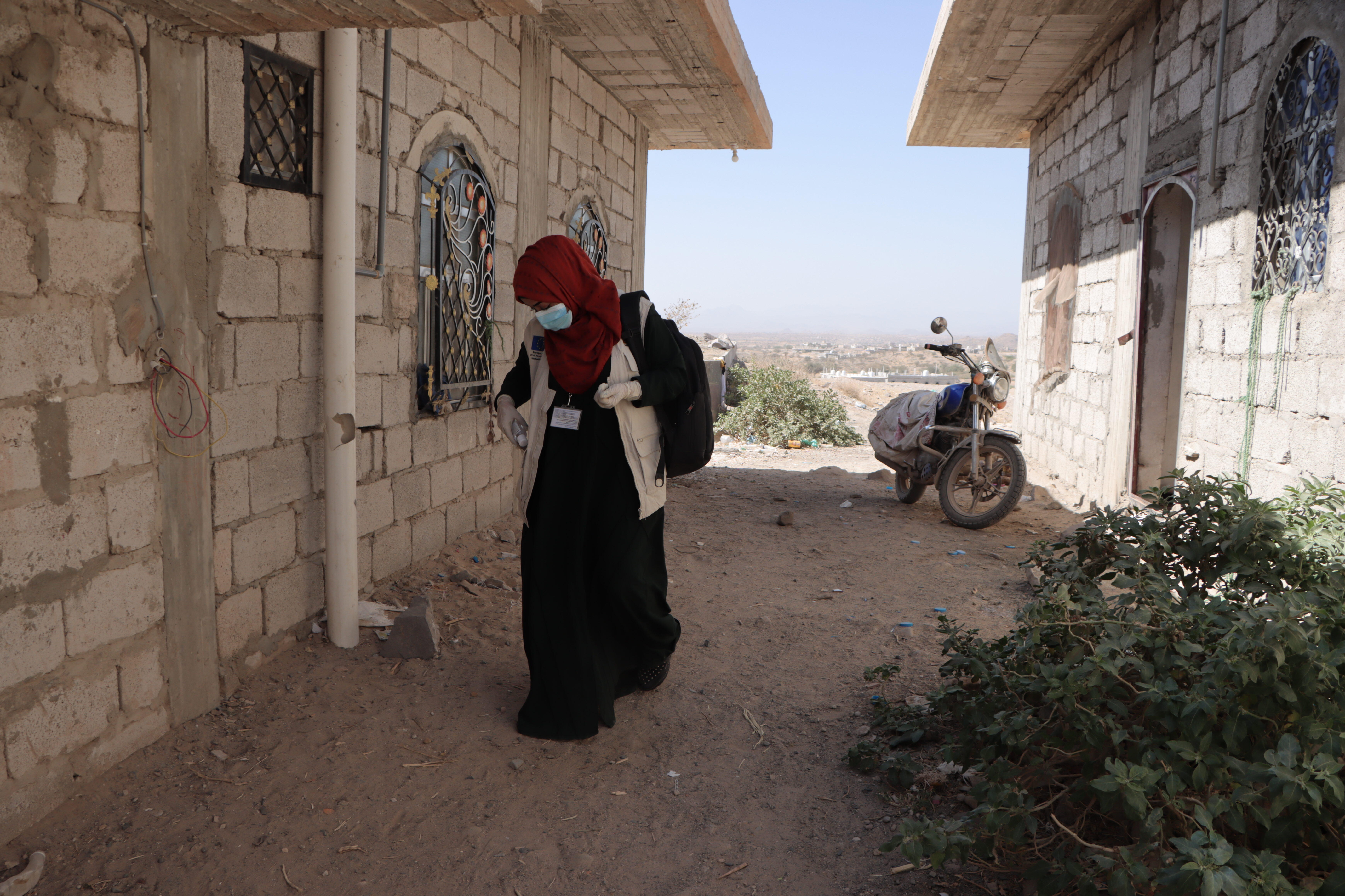 Dr. Bushra walking in a remote village in Yemen, where she travels with an IRC mobile medical team to provide reproductive health care to women.