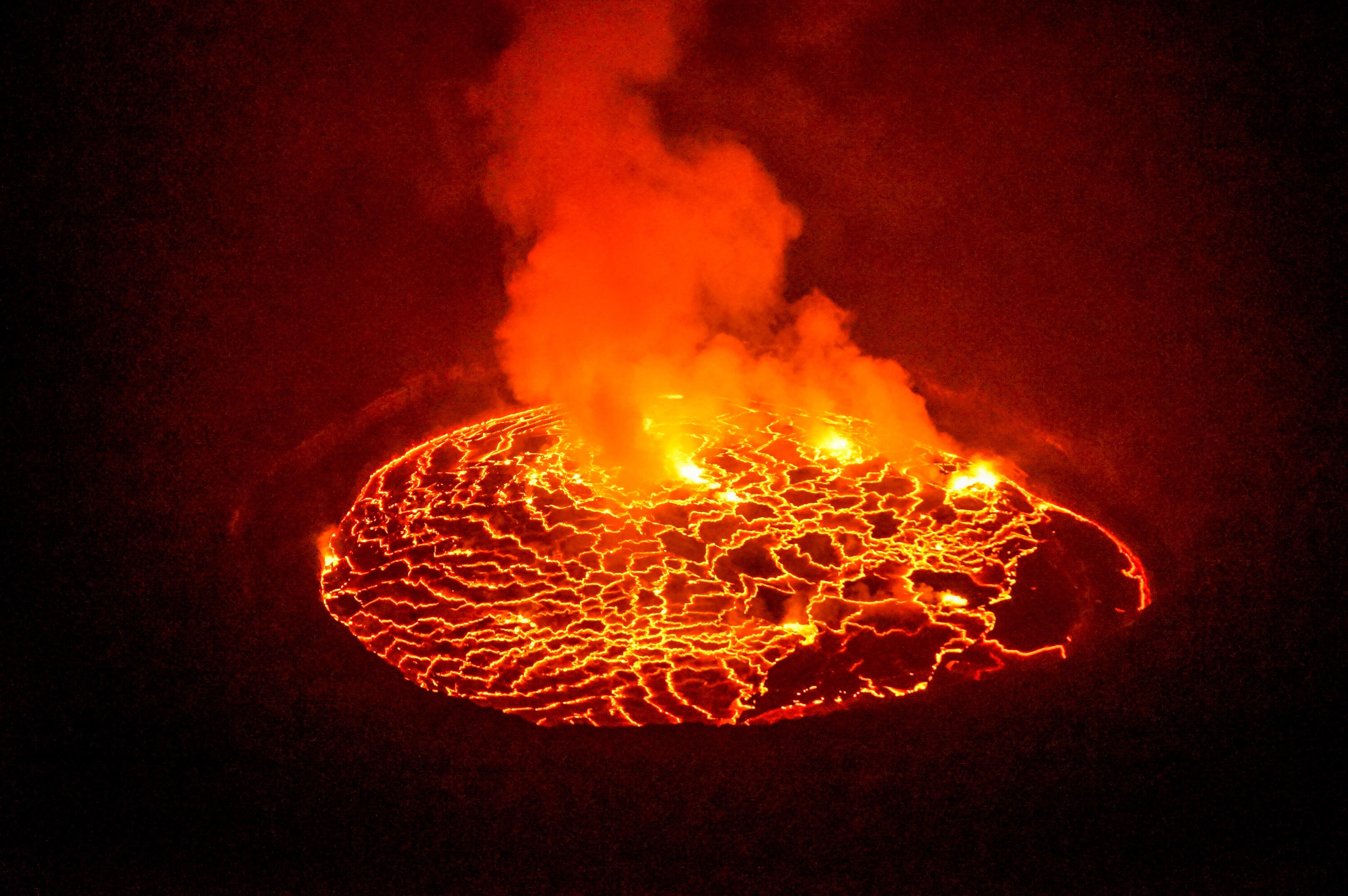 Aerial view of steaming lava lake in the glowing crater of Mt. Nyiragongo near Goma