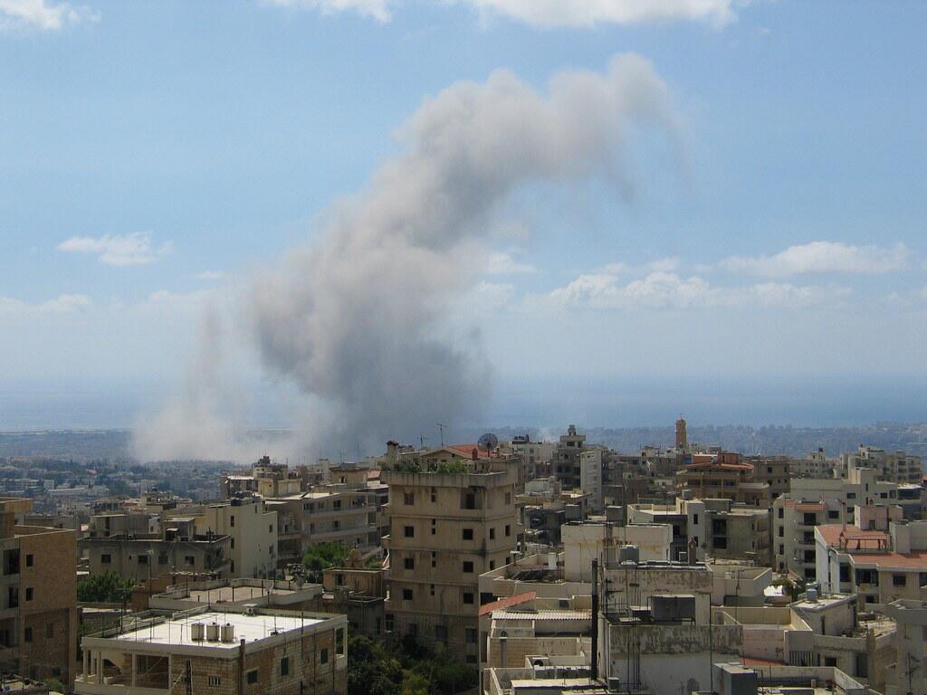 The skyline of Beirut with a huge plume of smoke in the background.