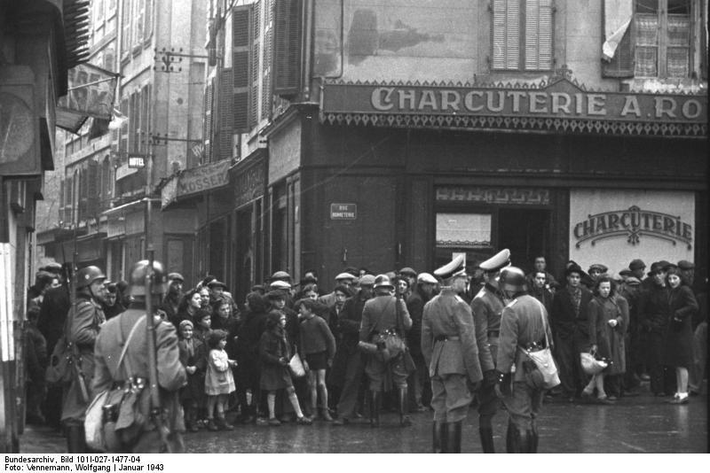 People are rounded up by Nazi forces outside a butcher shop in Marseilles, France