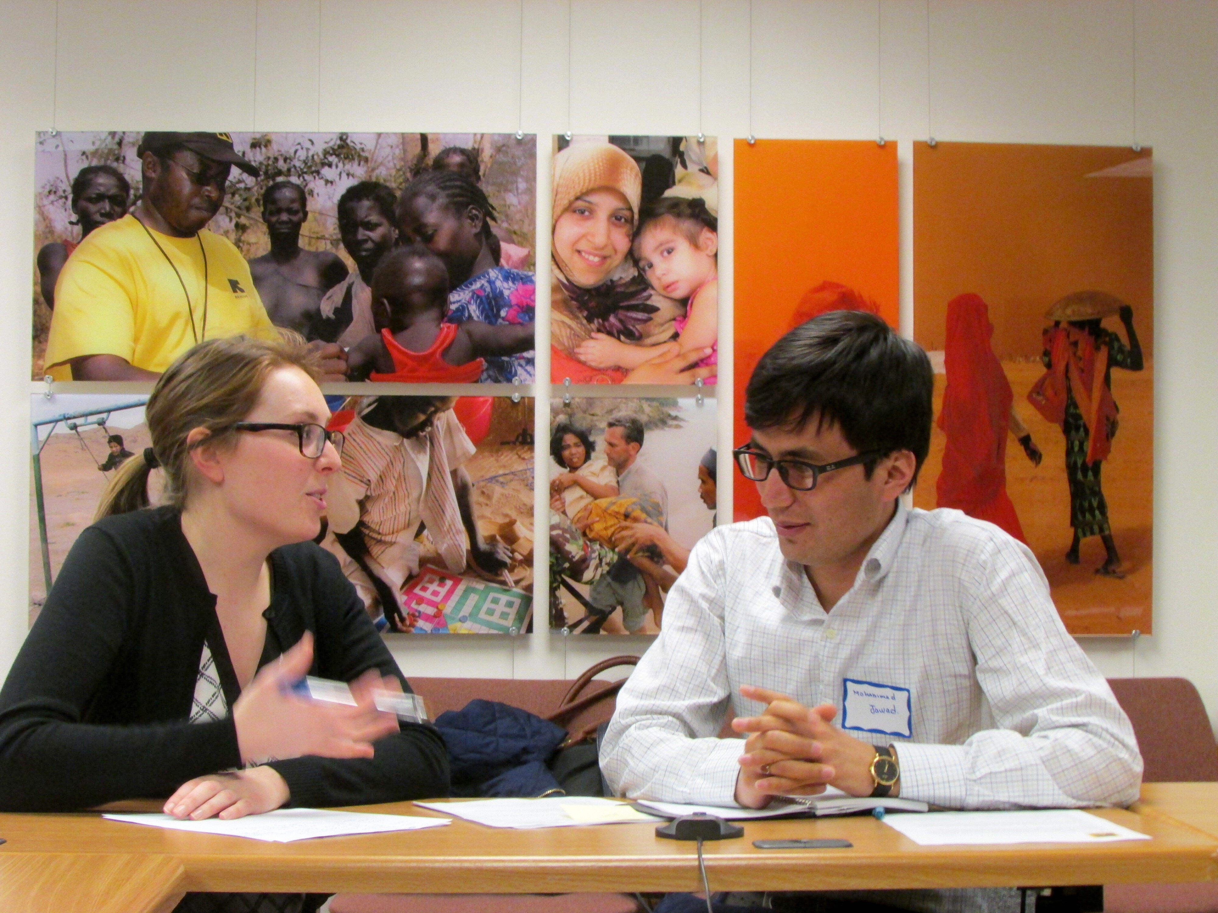 IRC Volunteer coaches a client from Afghanistan at a resume writing workshop.