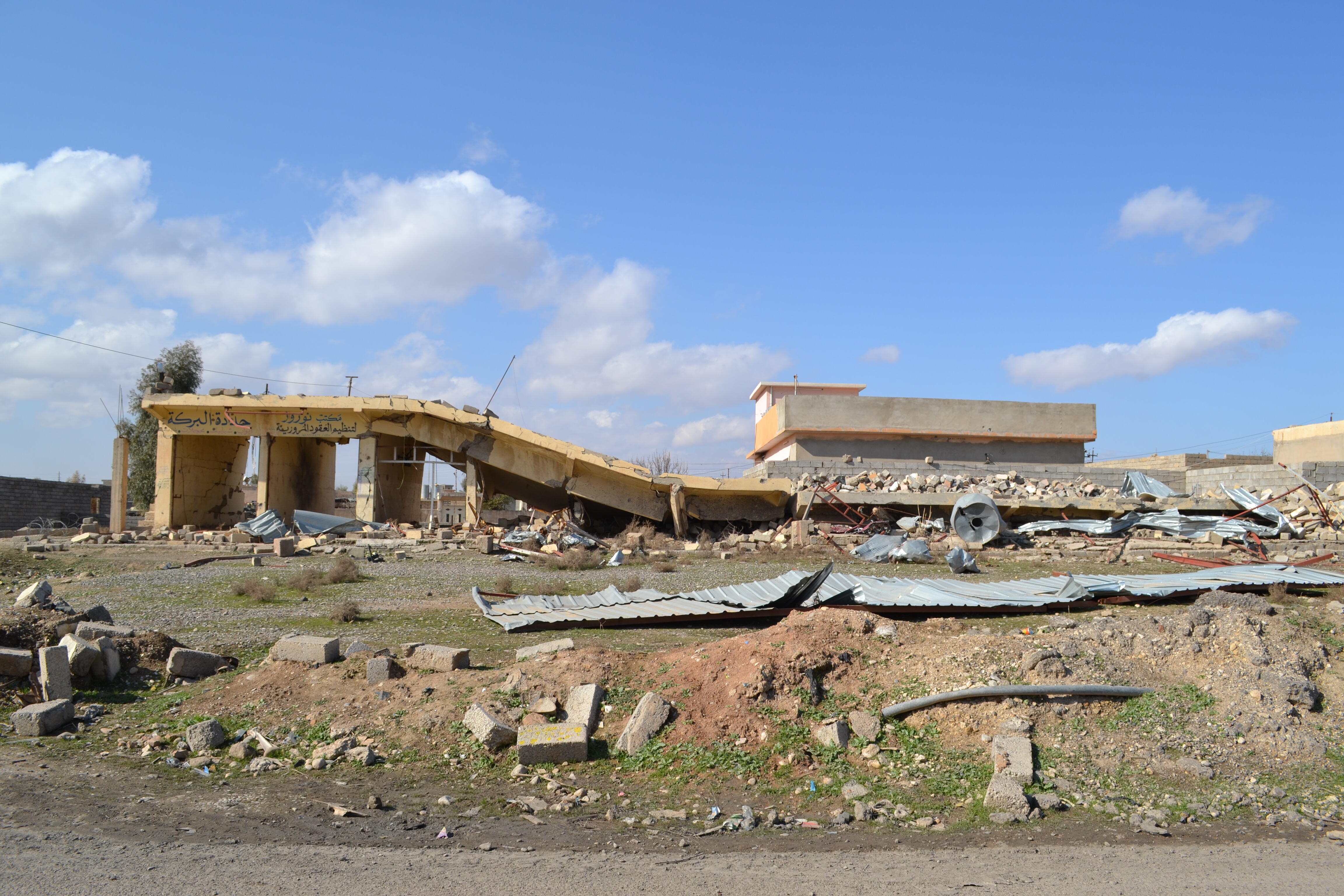 A collapsed row of shops, severely damaged by heavy fighting to retake the village of Baybokht from ISIS towards the beginning of battle for Mosul 