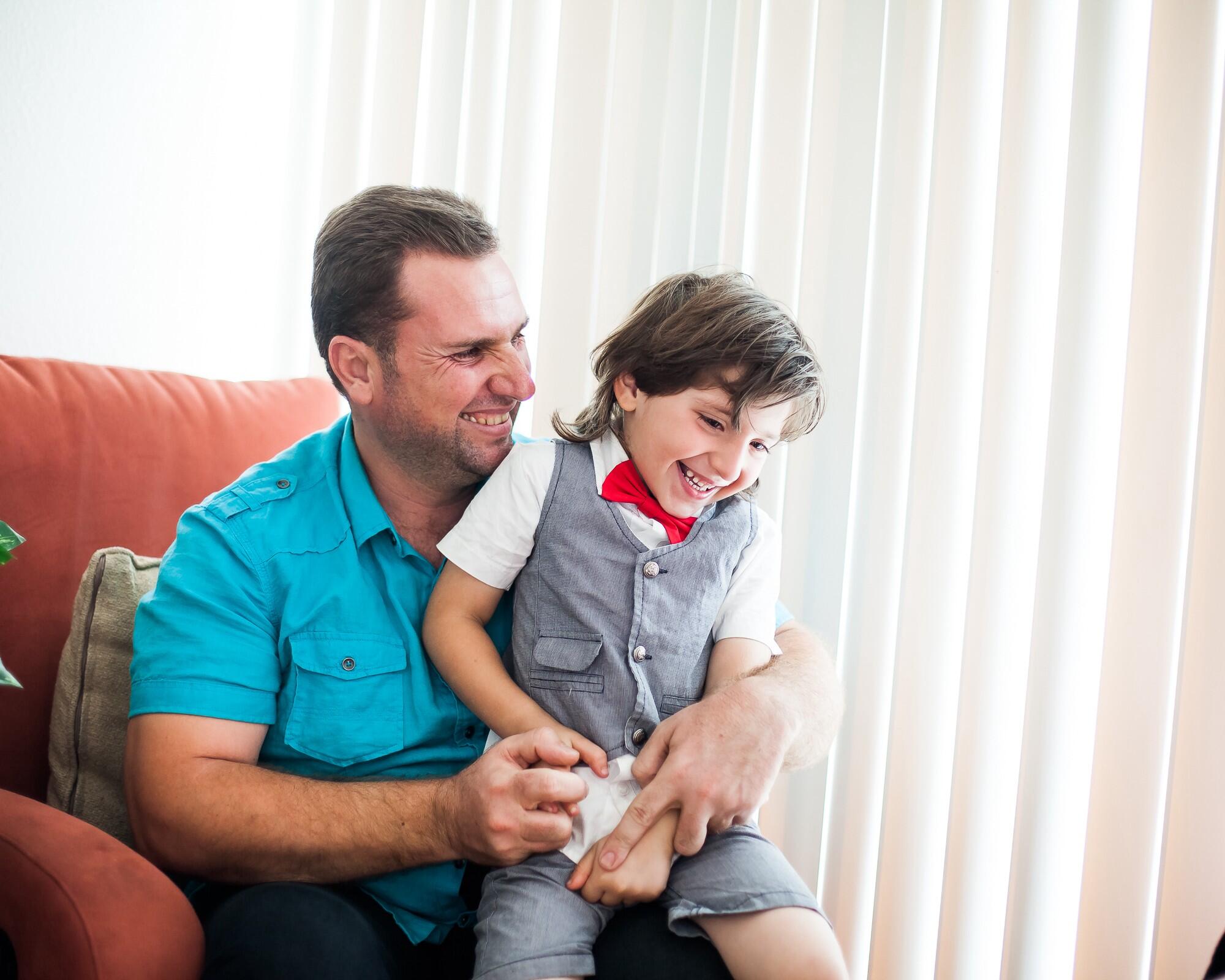 Hamzah sits with his his five-year-old son Abdullah in their Oakland, California home.