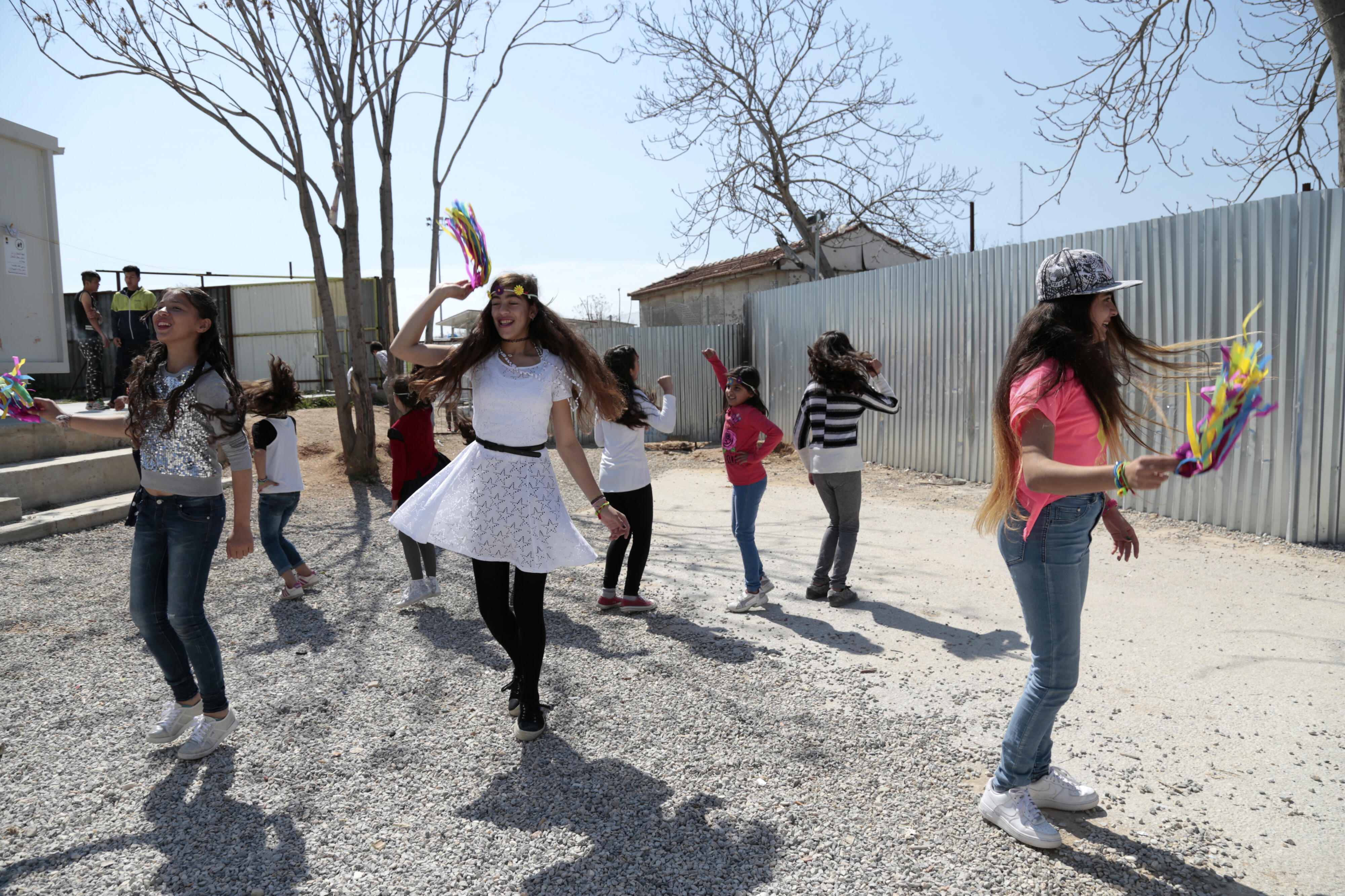 Girls dance at an IRC safe healing and learning space in Eleaonas refugee camp in Greece.