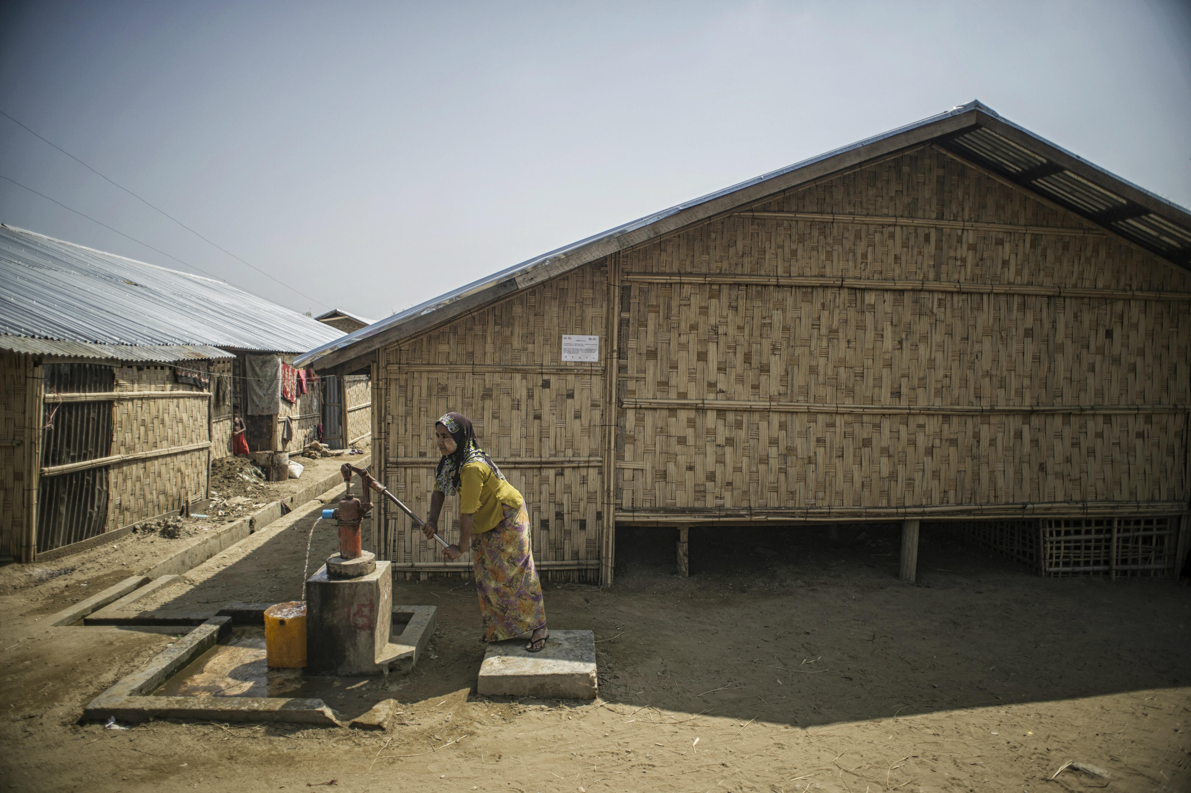 A woman pumps water