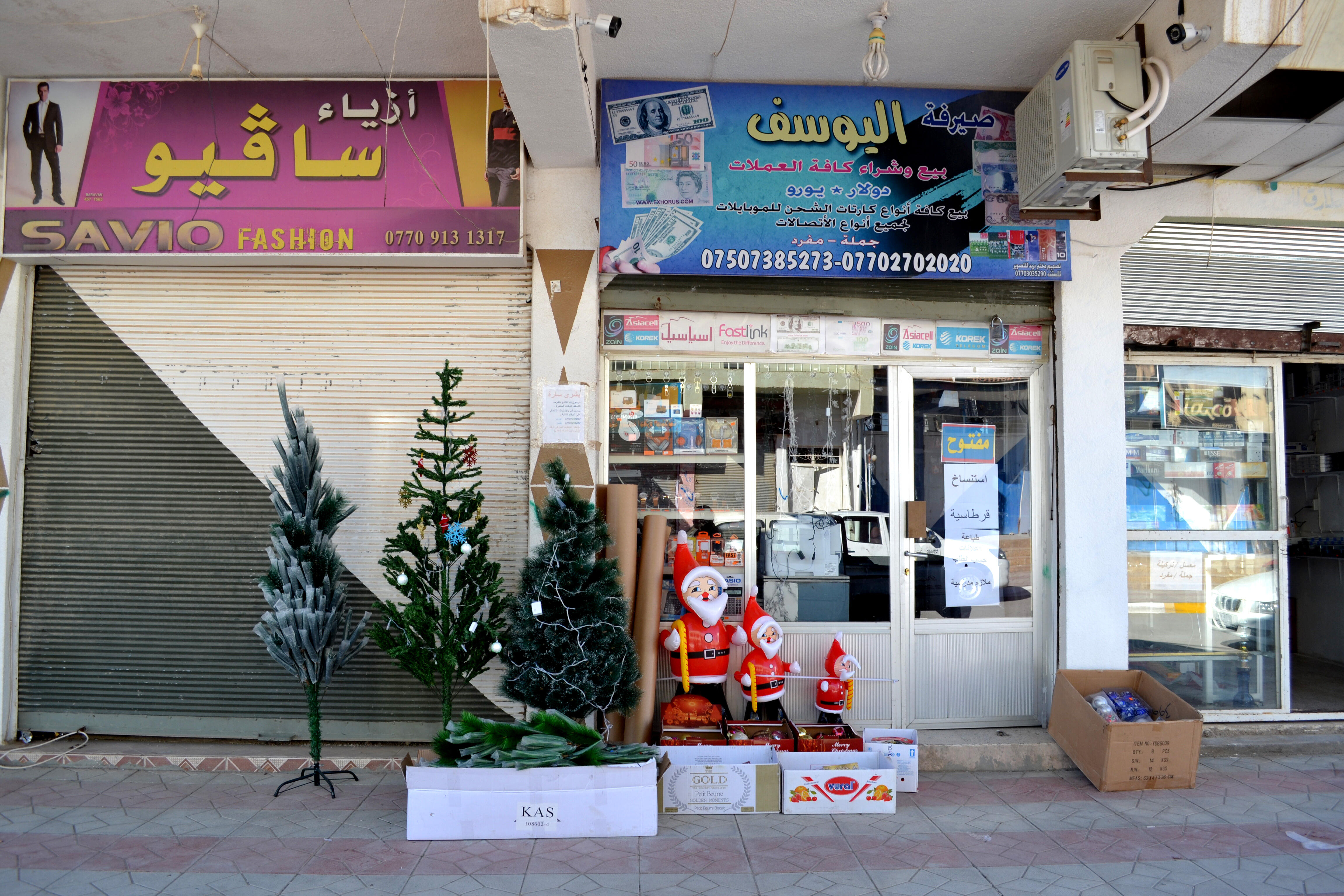 Christmas trees and Santa decorations displayed for sale outside a shop in northern Iraq
