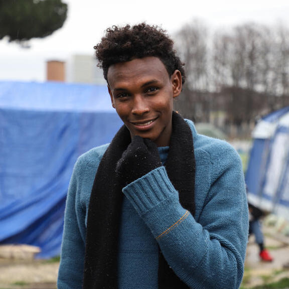 A young migrant in a makeshift settlement in Italy.